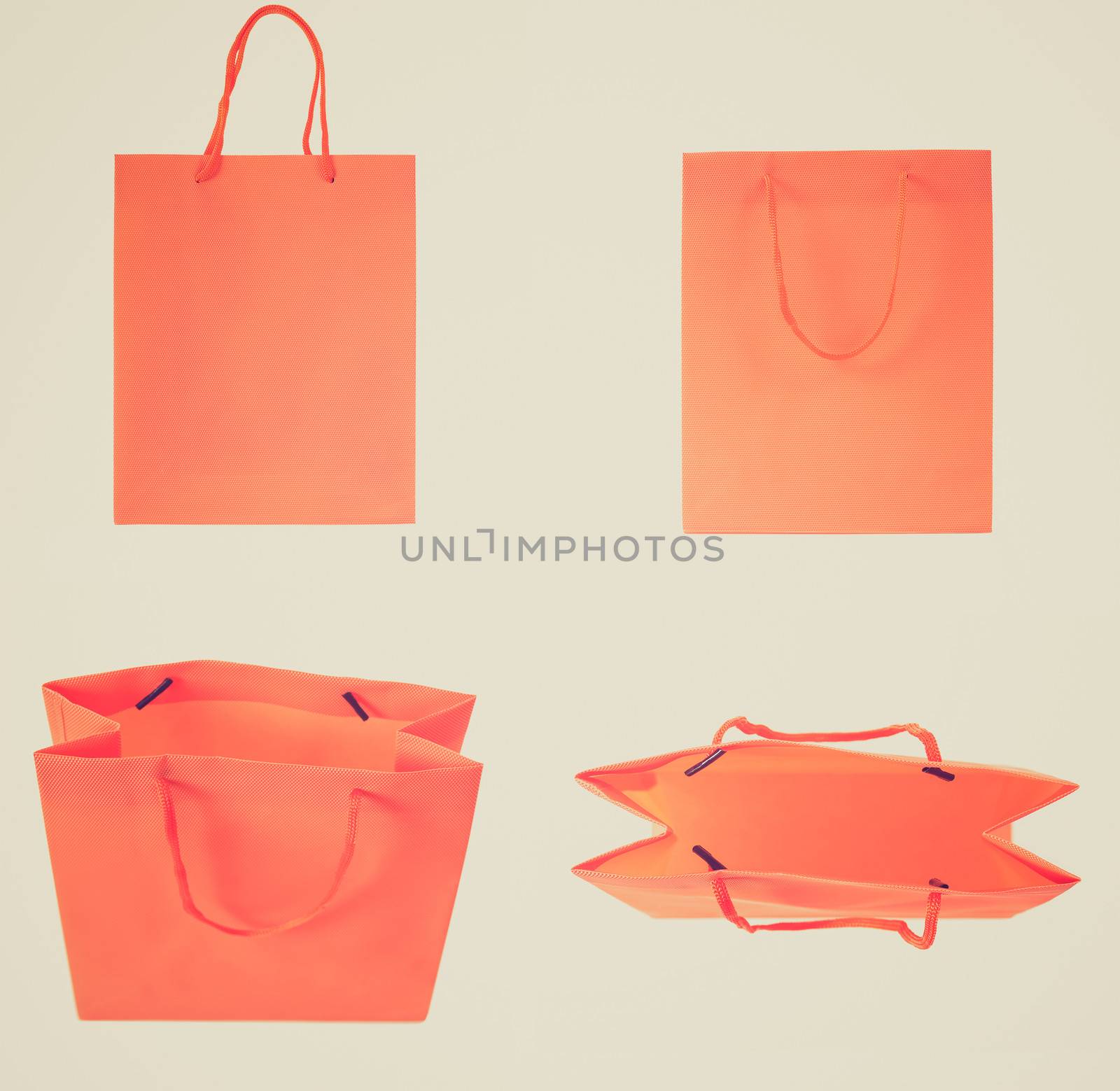 Vintage retro looking Set of orange shopping bags isolated over white background