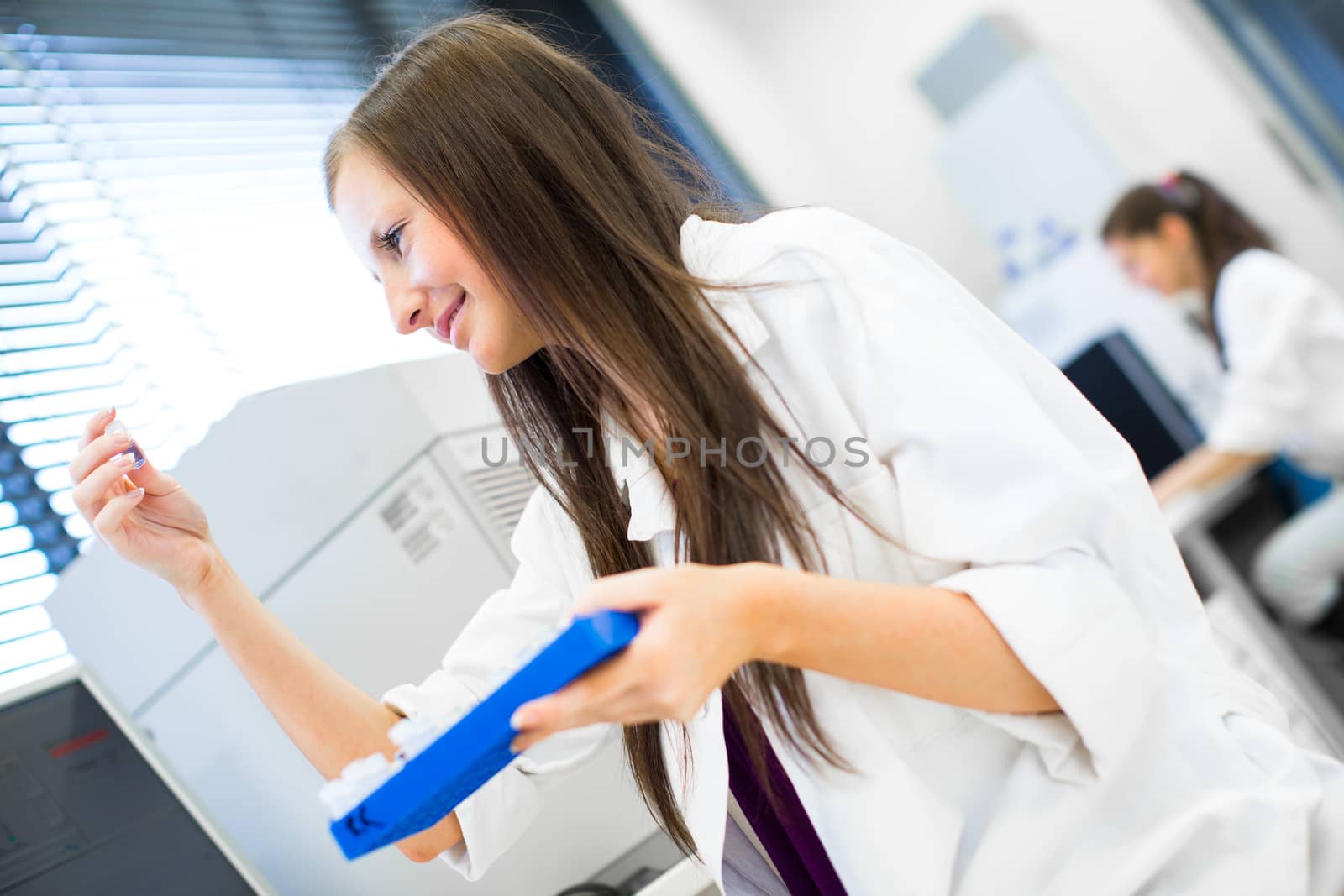 Portrait of a female chemistry student carrying out research in a chemistry lab (color toned image; shallow DOF)