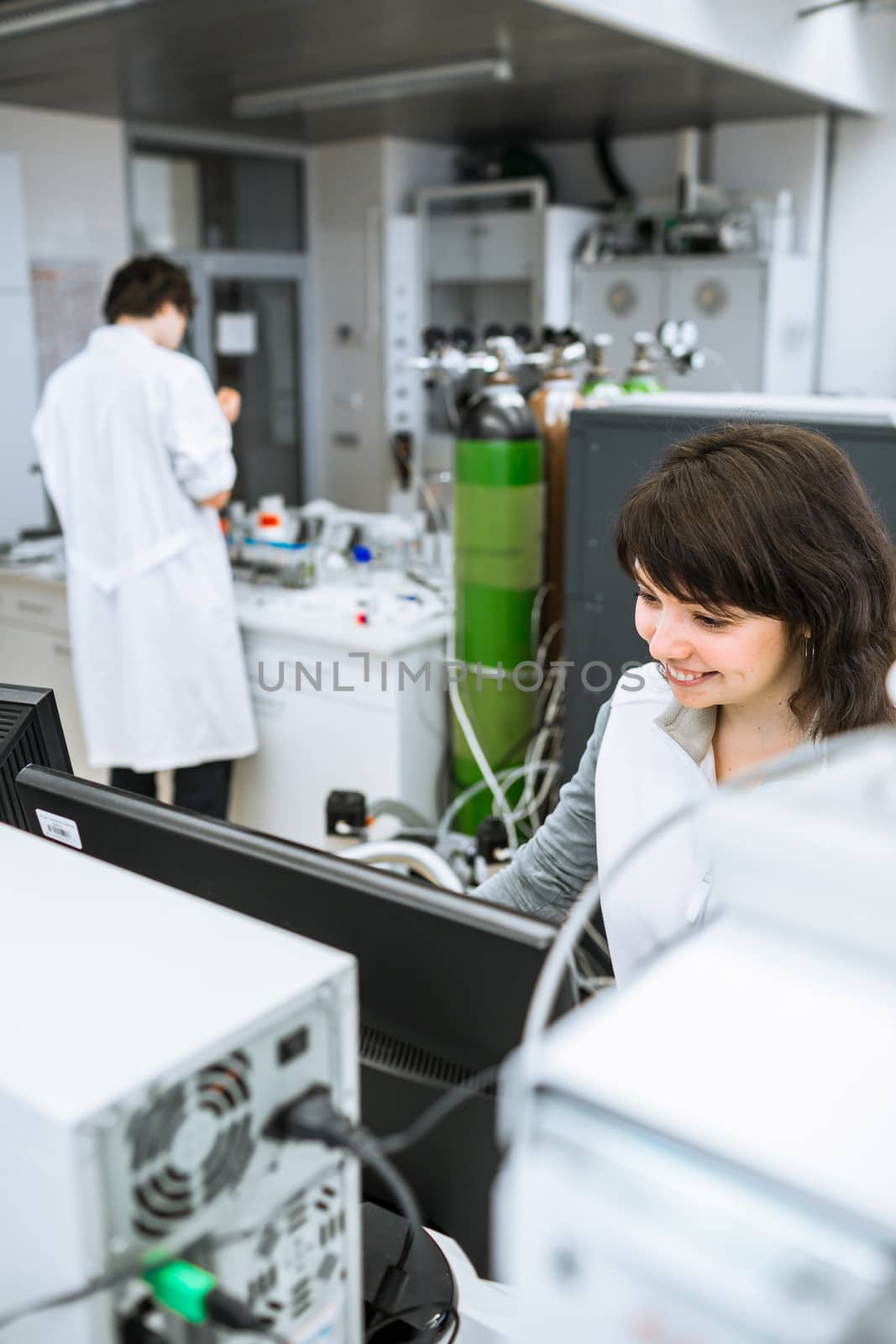 Portrait of a female researcher doing research in a lab (shallow DOF; color toned image)