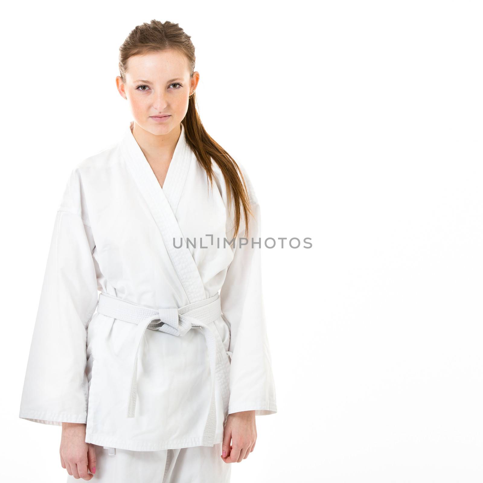 Beautiful caucasian, young, woman in karate kimono on white background
