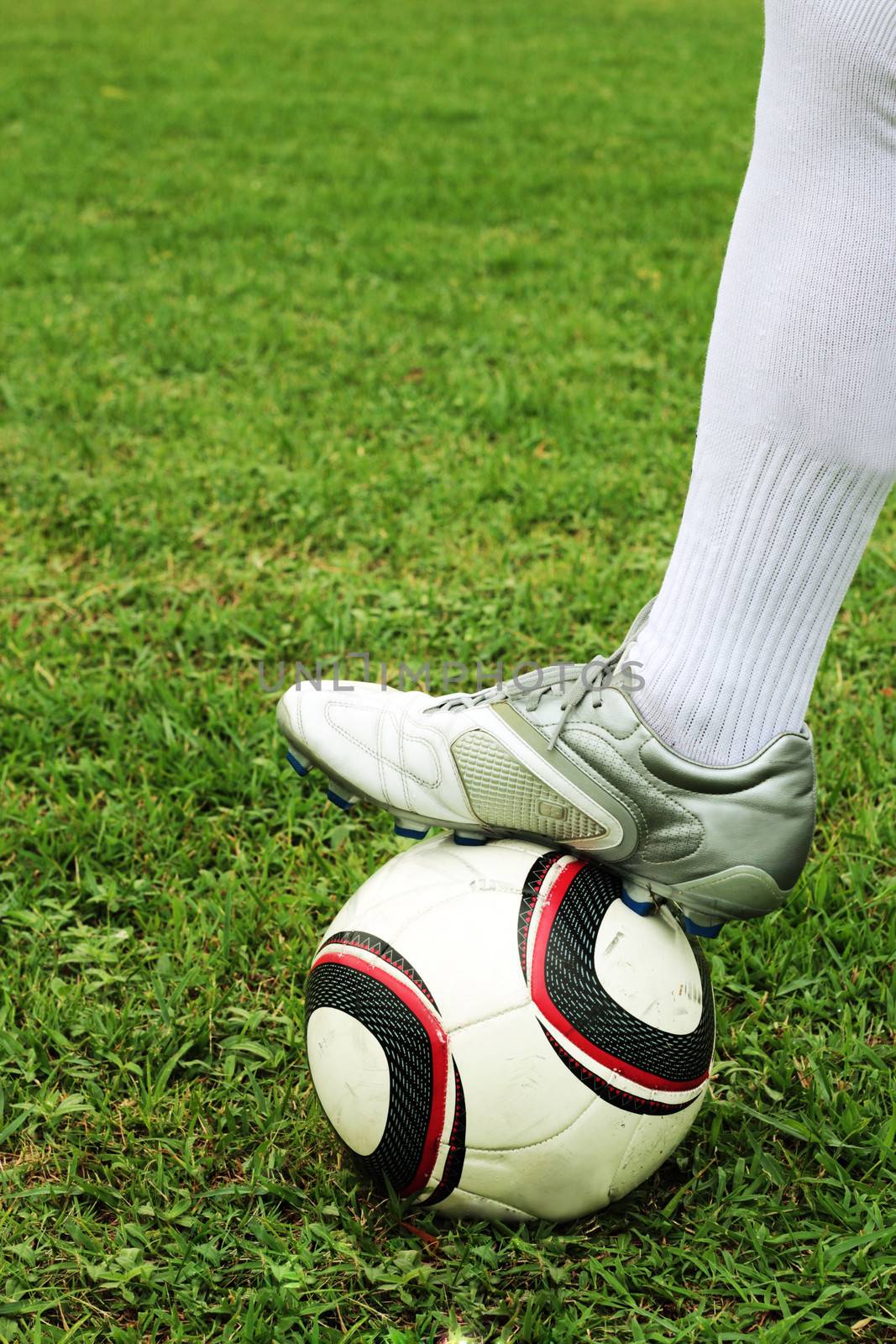 Footballer stepped on the ball, preparing to play.