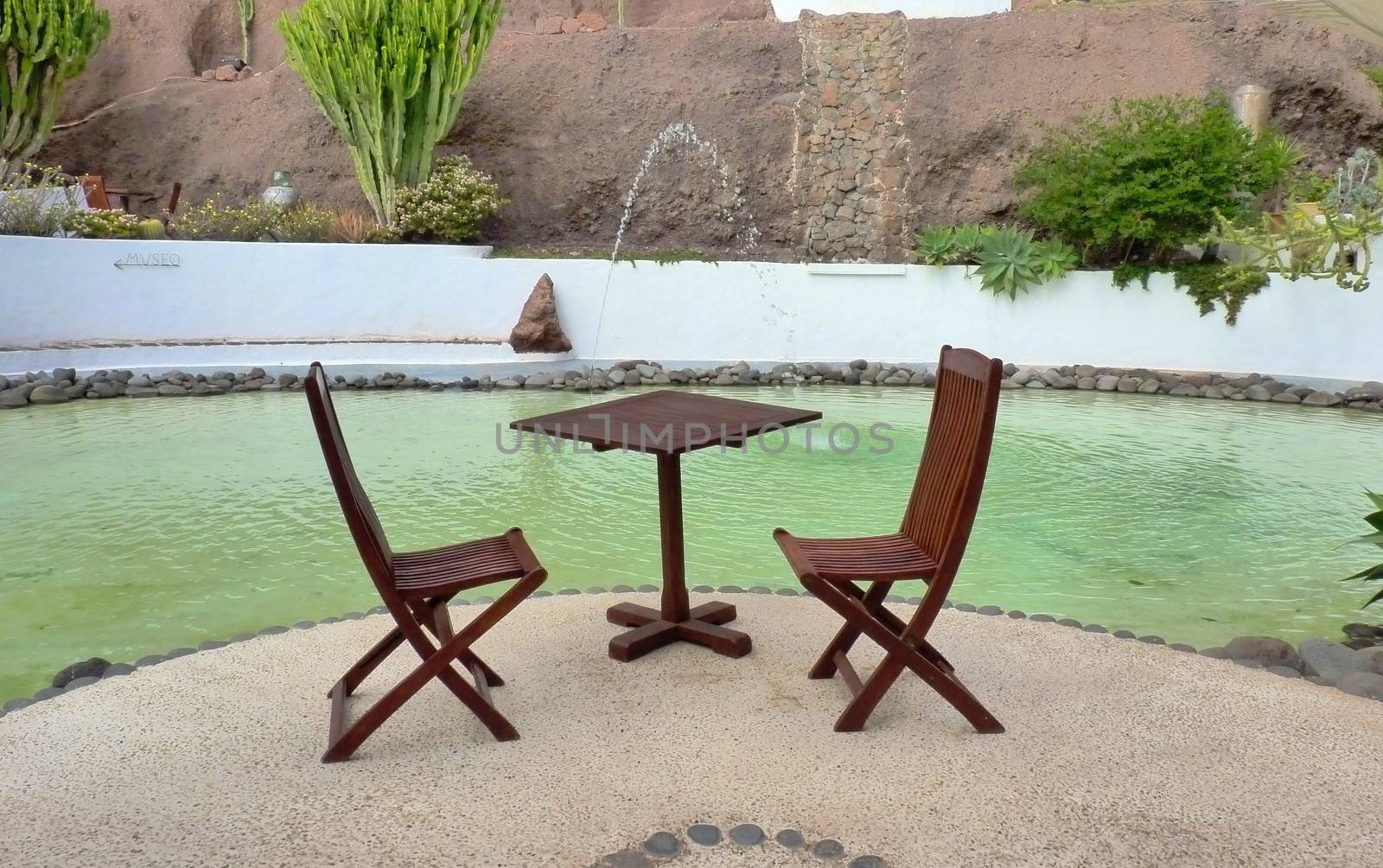 Table and chairs near a pool