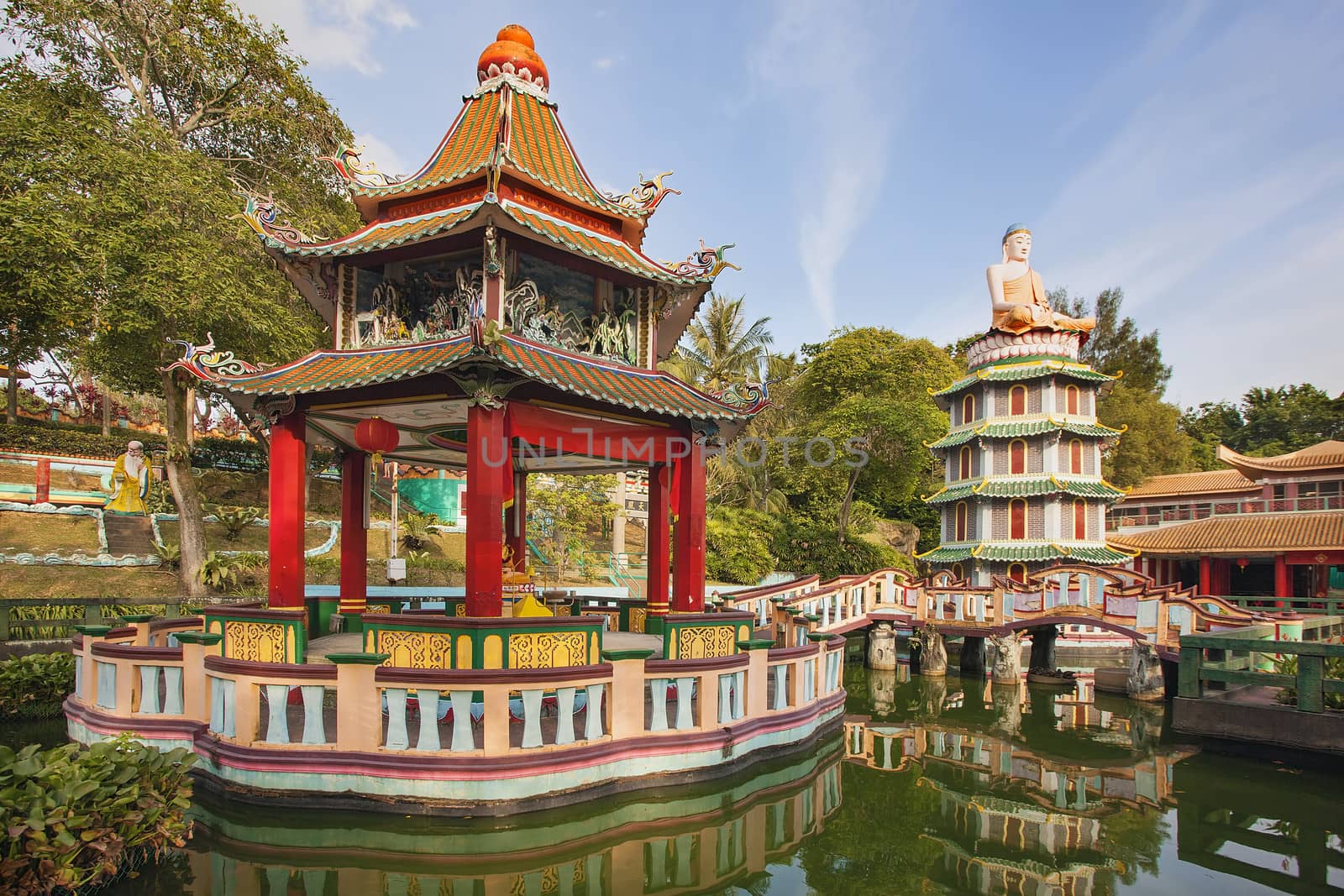 SINGAPORE - FEBRUARY 1, 2014: Chinese Pagoda and Pavilion by the Lake at Haw Par Villa Theme Park. This theme park contains over 1,000 statues and 150 giant dioramas depicting scenes from Chinese mythology, folklore, legends, and history.