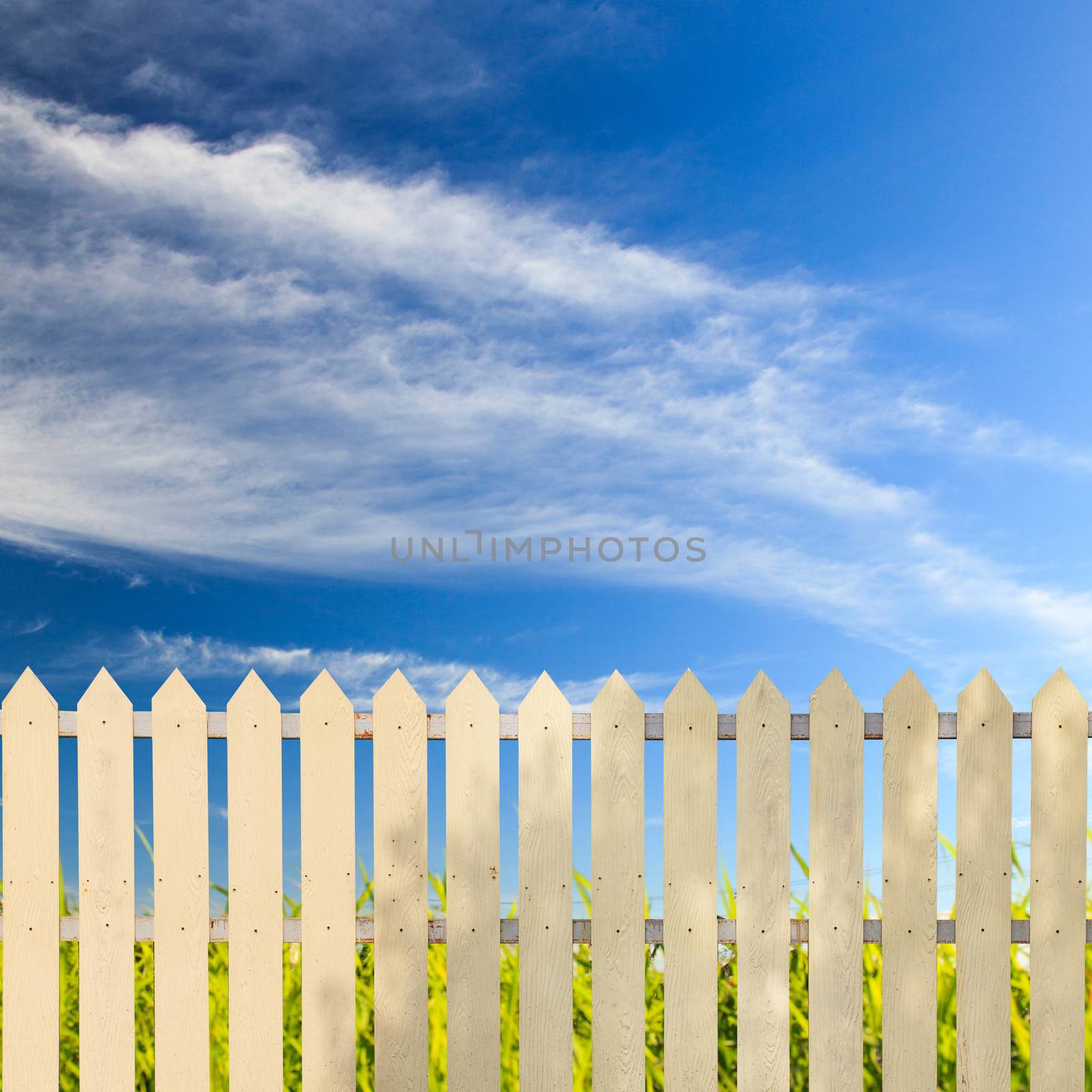 White fences with blue sky