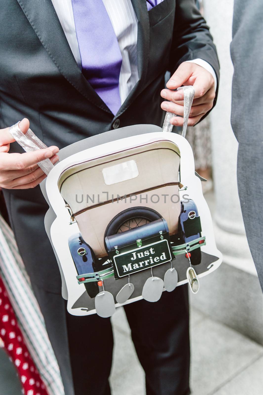 Carrier Bag with wedding motive in the hands of a groom