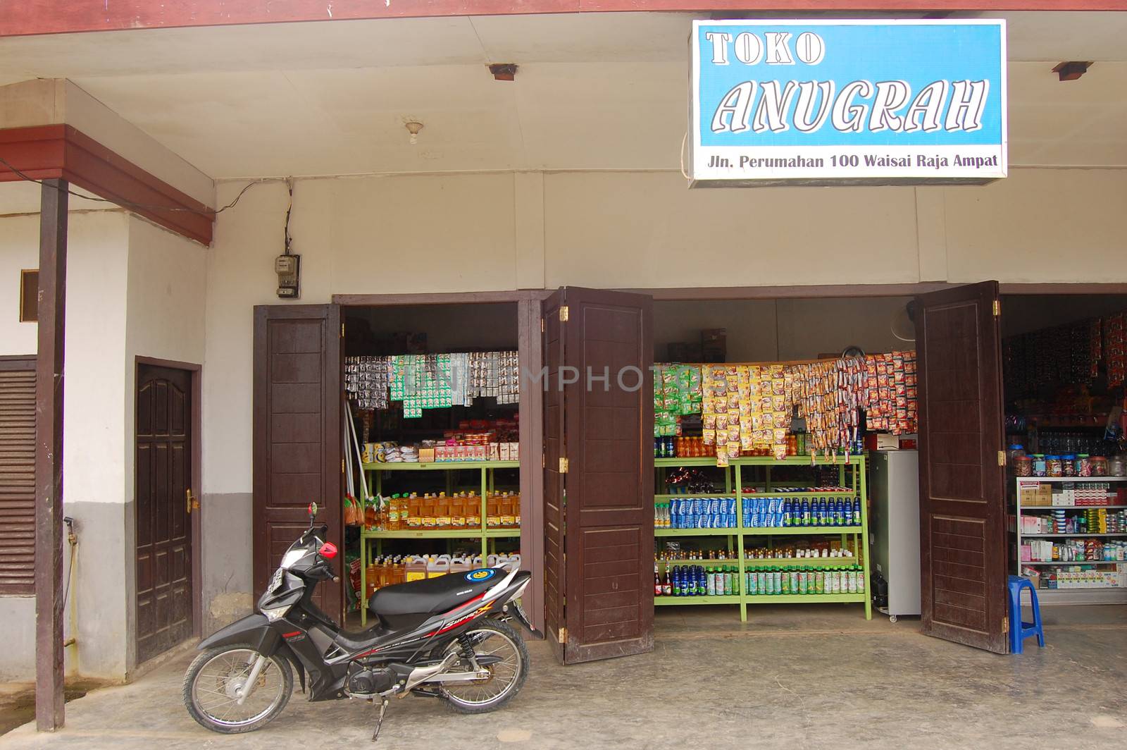 Motorcycle at store entrance Indonesian town