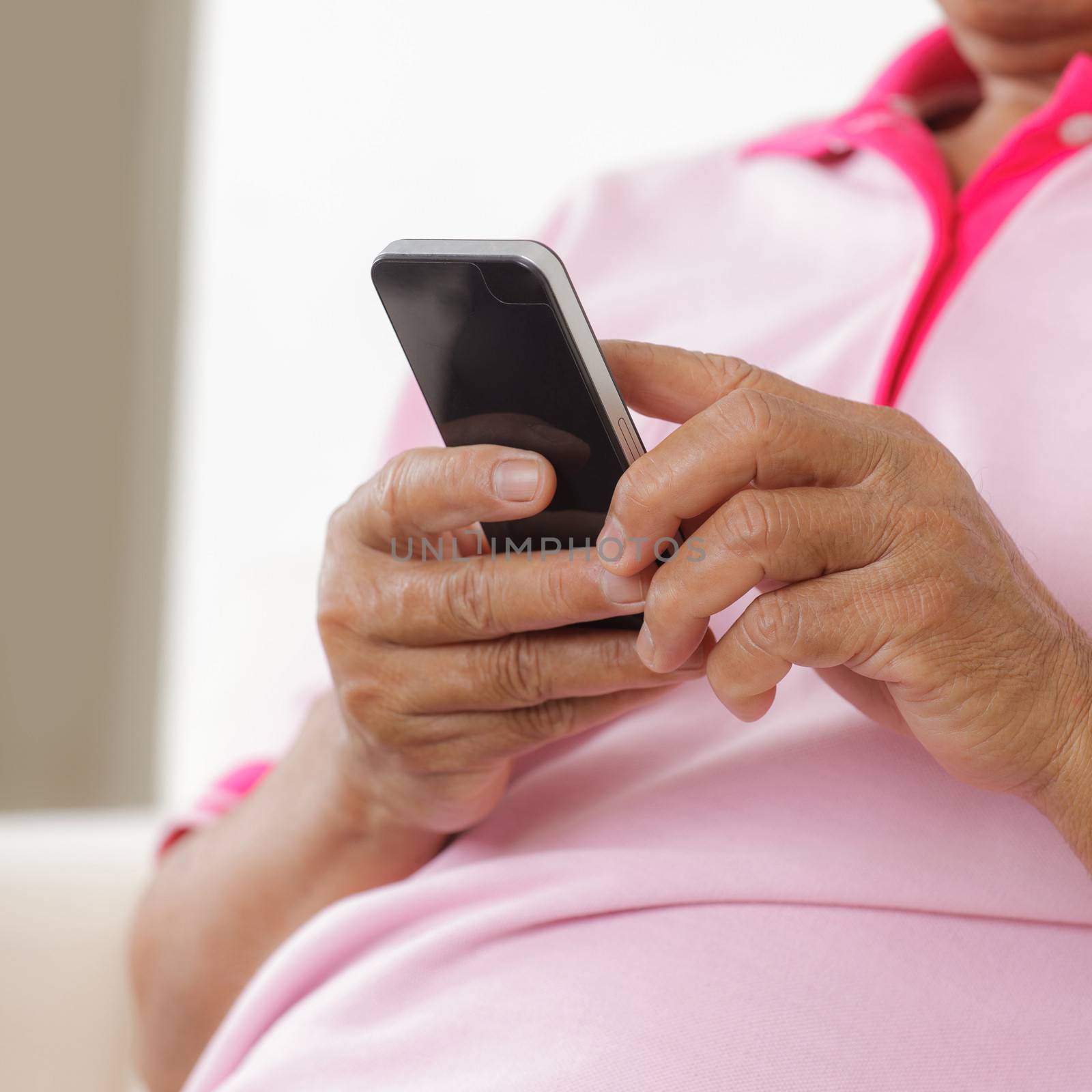 Portrait of Senior man using phone at home