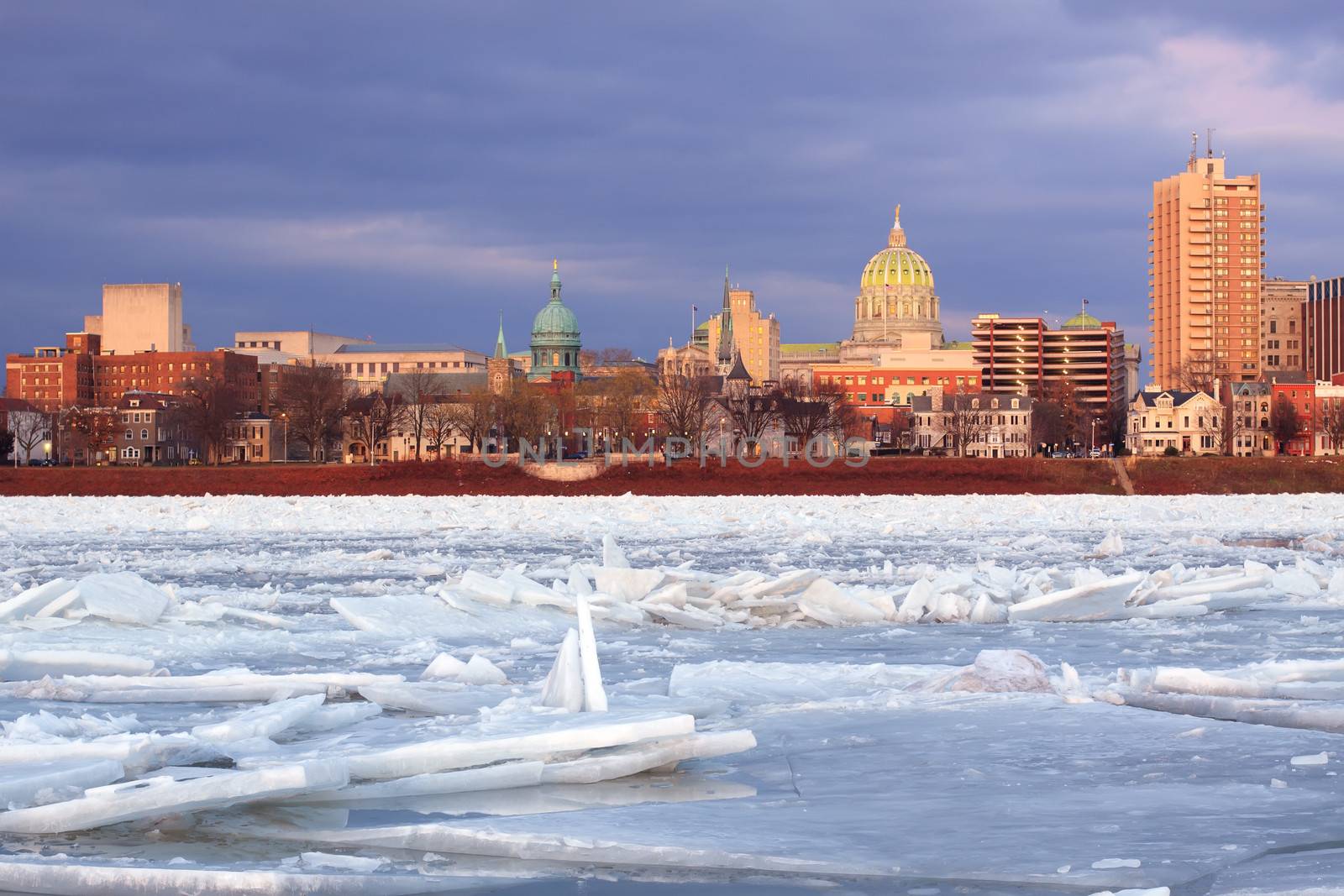 Harrisburg, Pennsylvania,illuminated by evening sunlight as viewed from City Island across the frozen Susquehanna River.