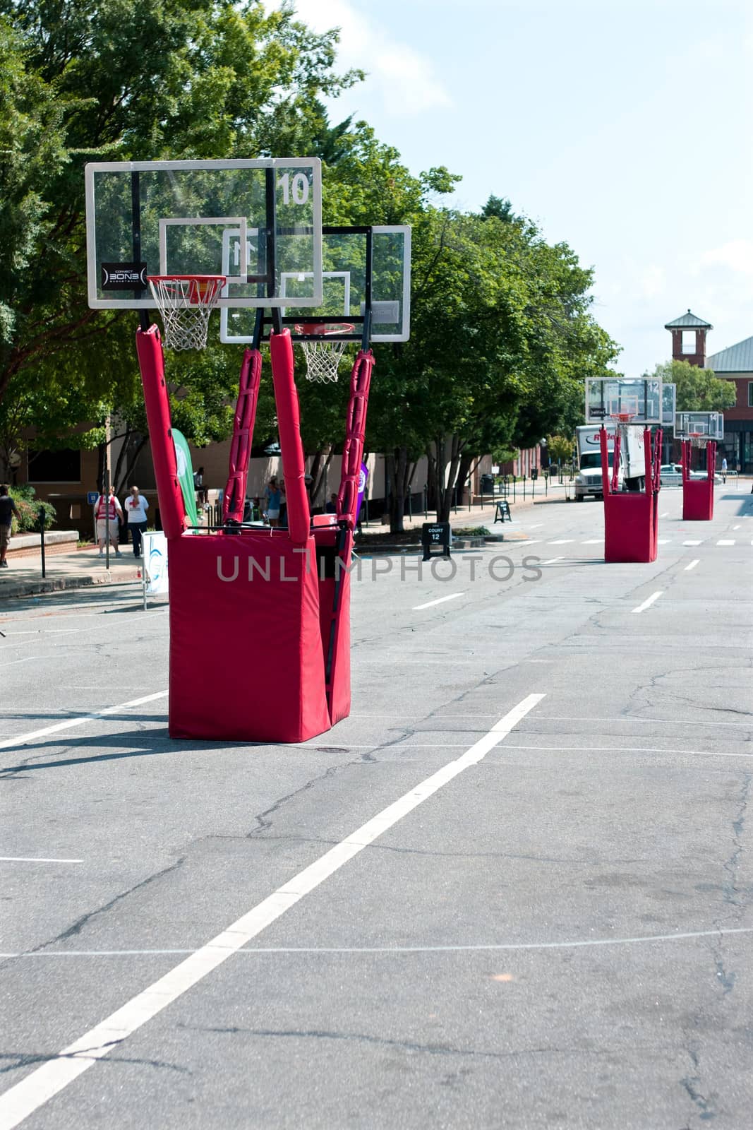 Athens, GA, USA - August 24, 2013:  Several basketball goals are set up for a 3-on-3 tournament being played on the streets of downtown Athens. 