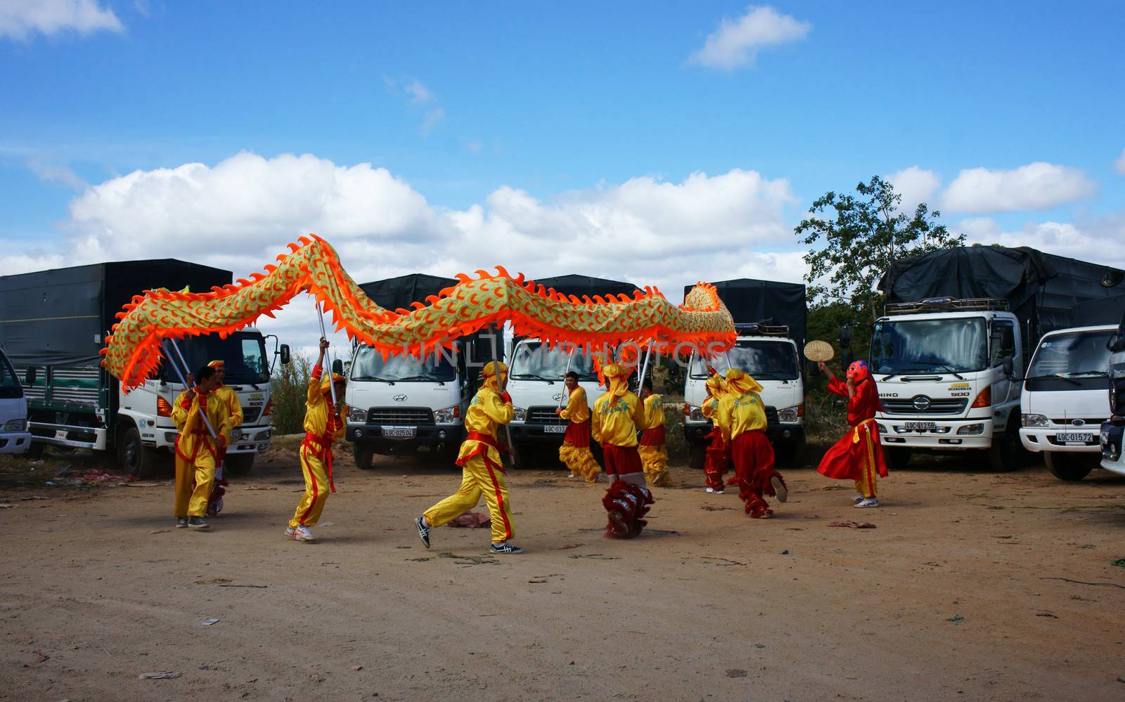 DA LAT, VIETNAM- JAN 31: Team of people perform dragon dance at truck park to celebrate New Year, this is oriental traditional custom to wish lucky , Viet Nam, Jan 31, 2014                           