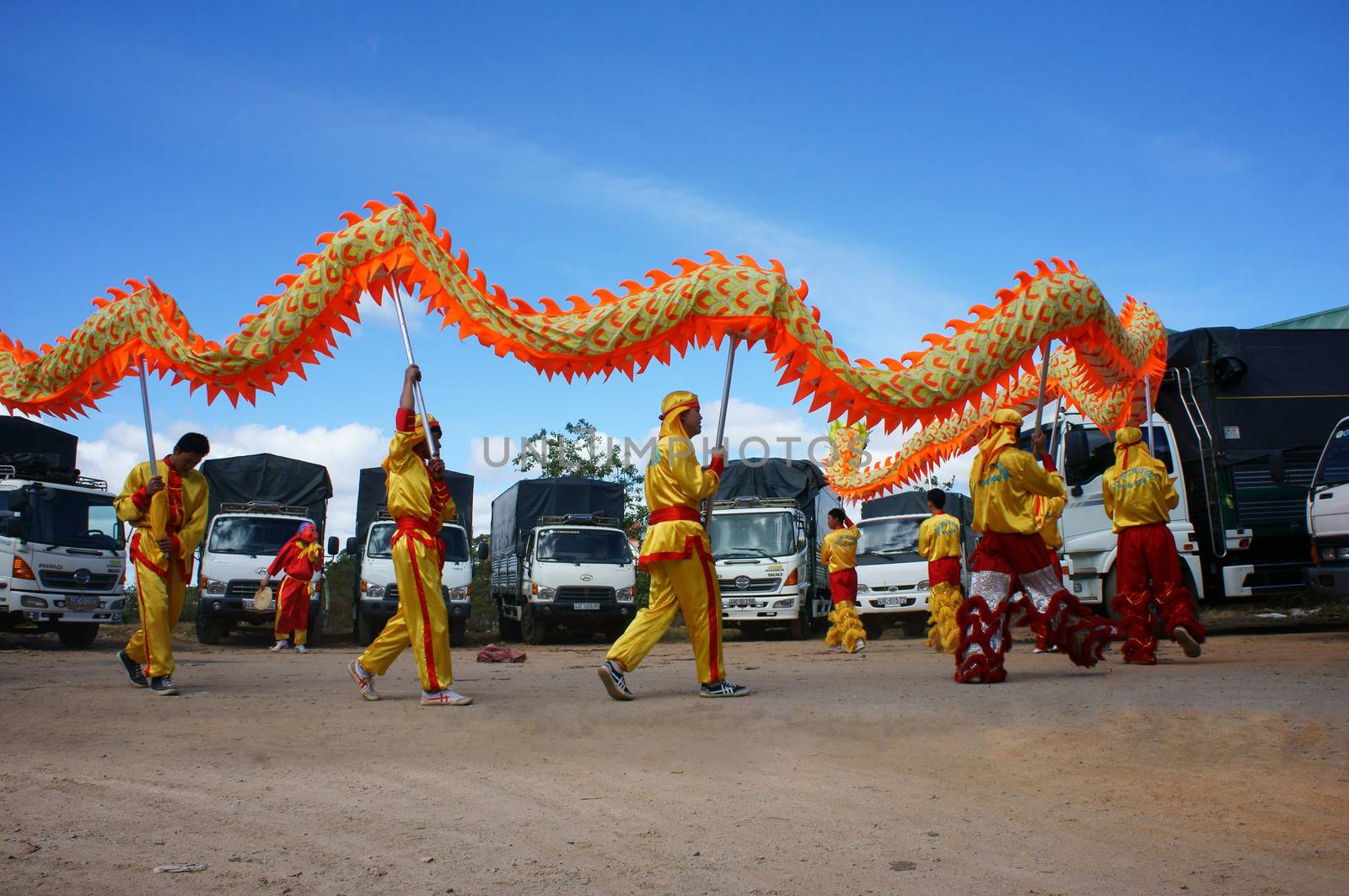 DA LAT, VIETNAM- JAN 31: Team of people perform dragon dance at truck park to celebrate New Year, this is oriental traditional custom to wish lucky , Viet Nam, Jan 31, 2014                           