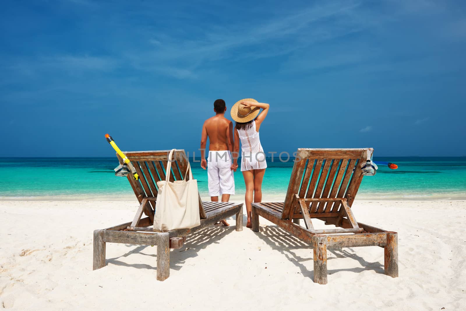 Couple in white on a tropical beach at Maldives