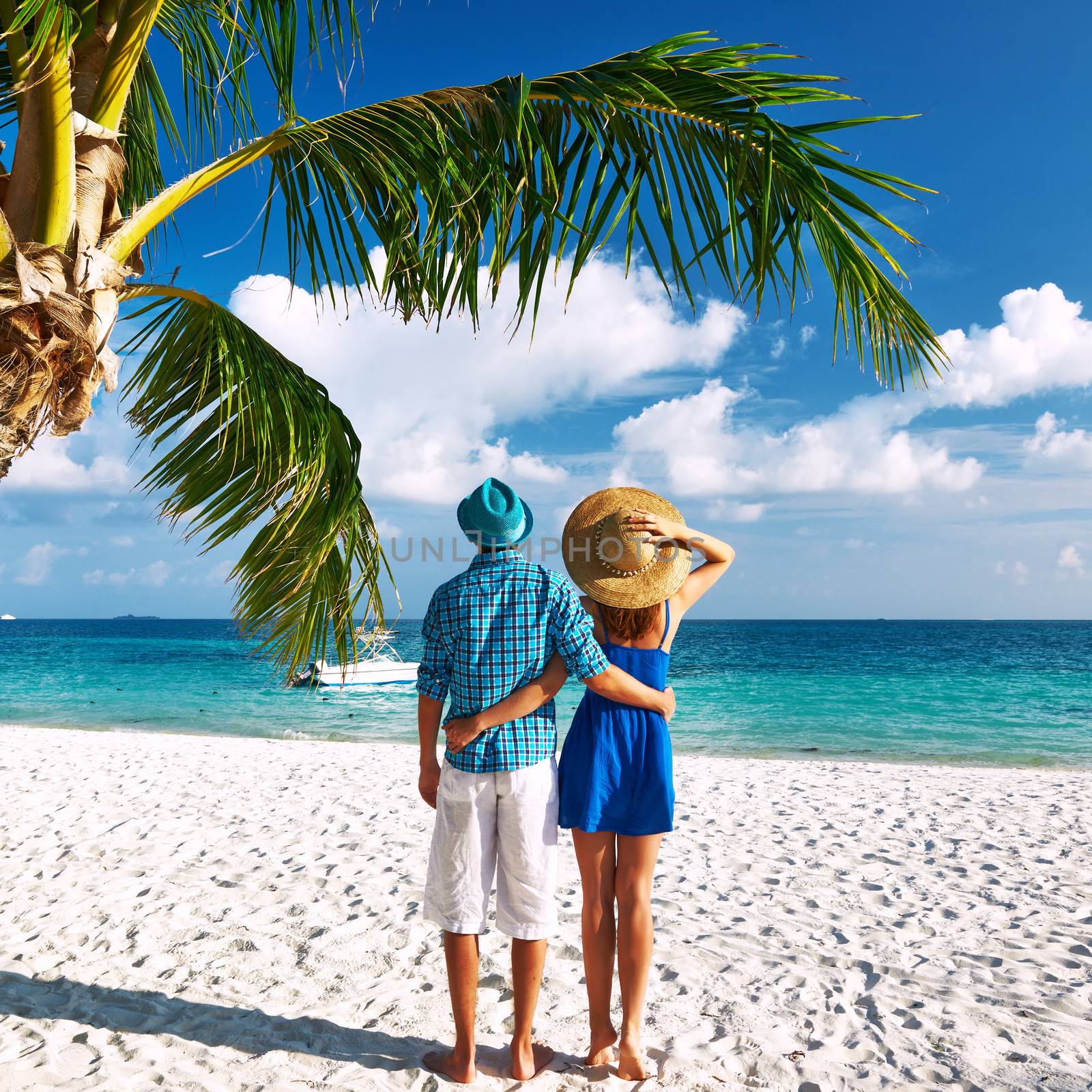 Couple in blue clothes on a beach at Maldives by haveseen