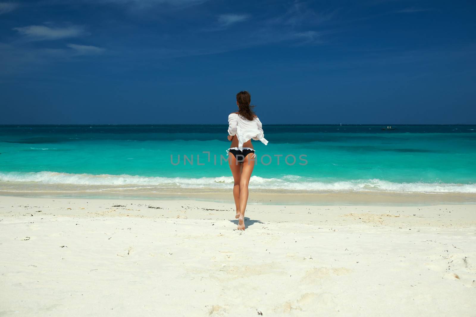 Woman in bikini at tropical beach