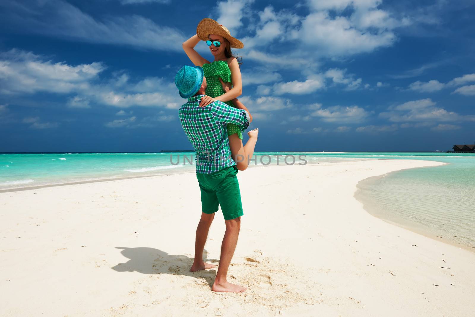 Couple in green on a tropical beach at Maldives