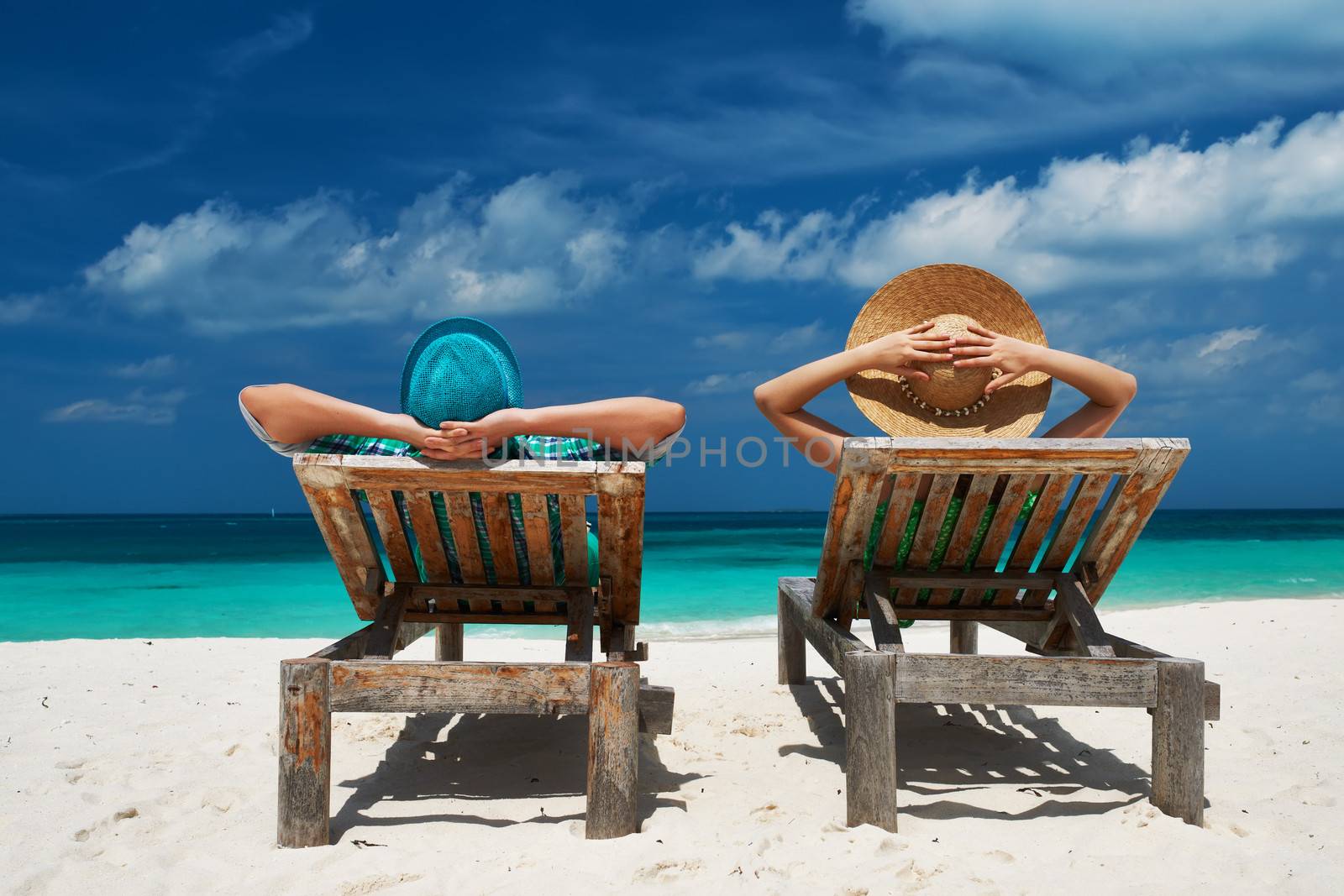 Couple in green on a tropical beach at Maldives