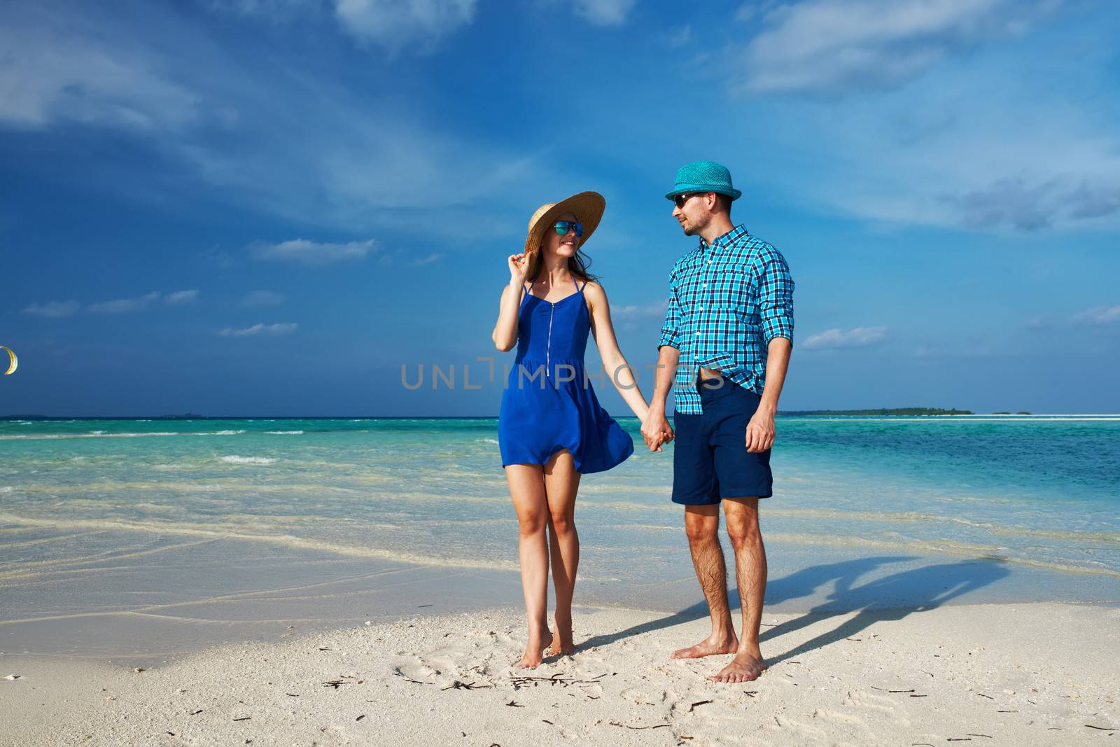 Couple in blue on a beach at Maldives by haveseen