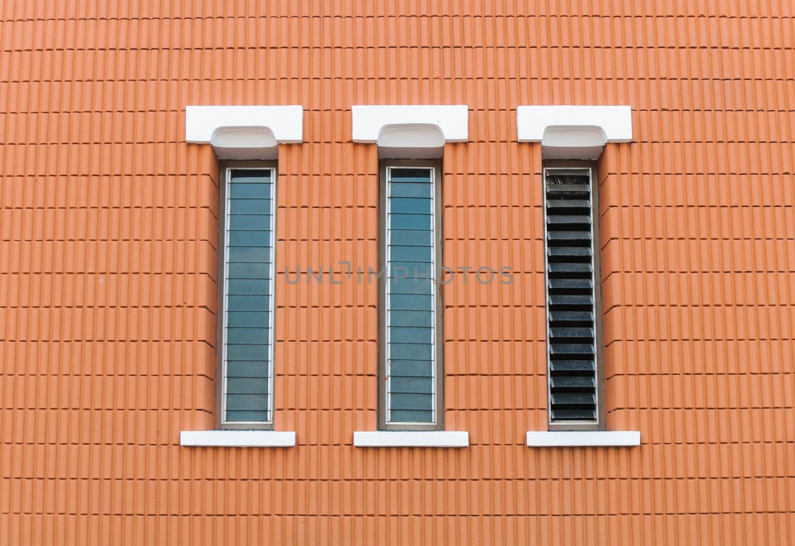 three window in a brick wall building