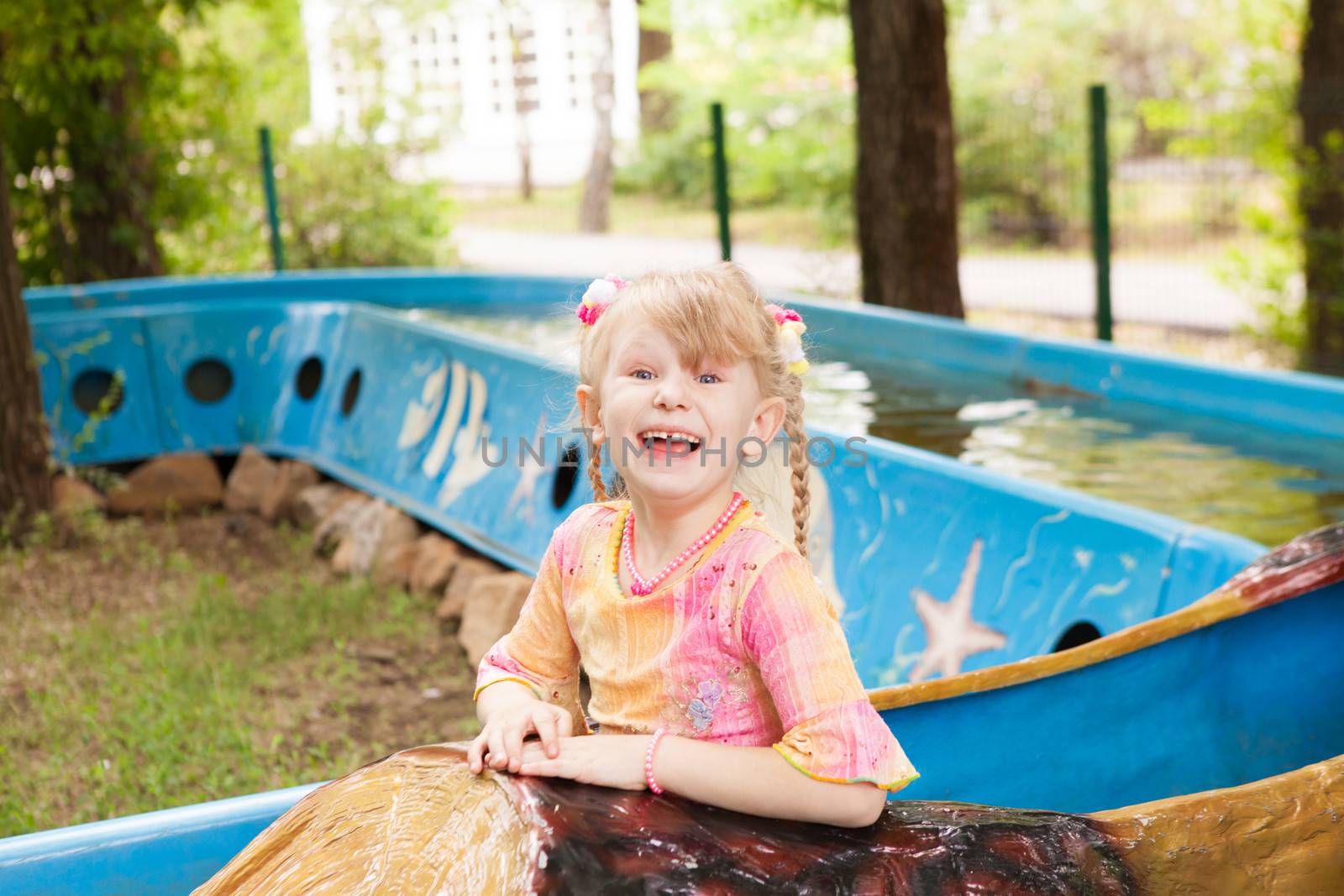 child in the boat in the park