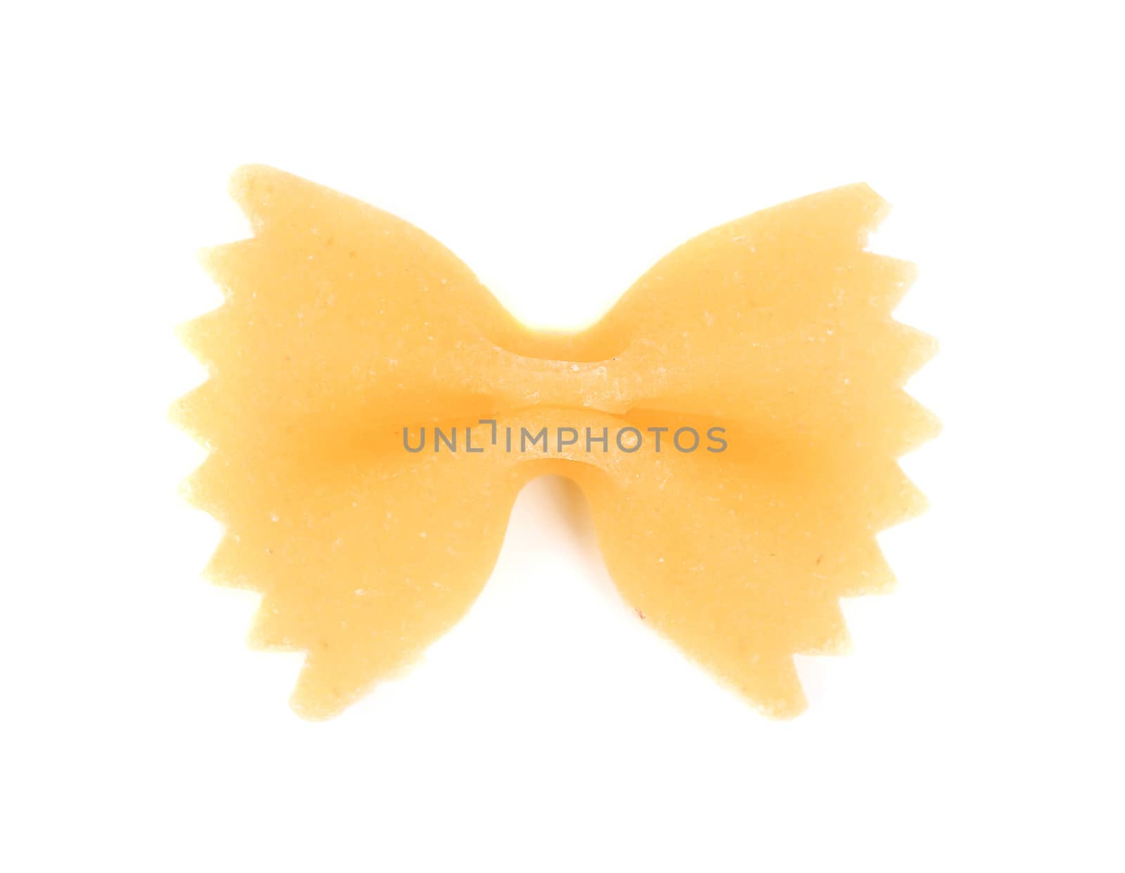One yellow farfalle. Isolated on a white background.