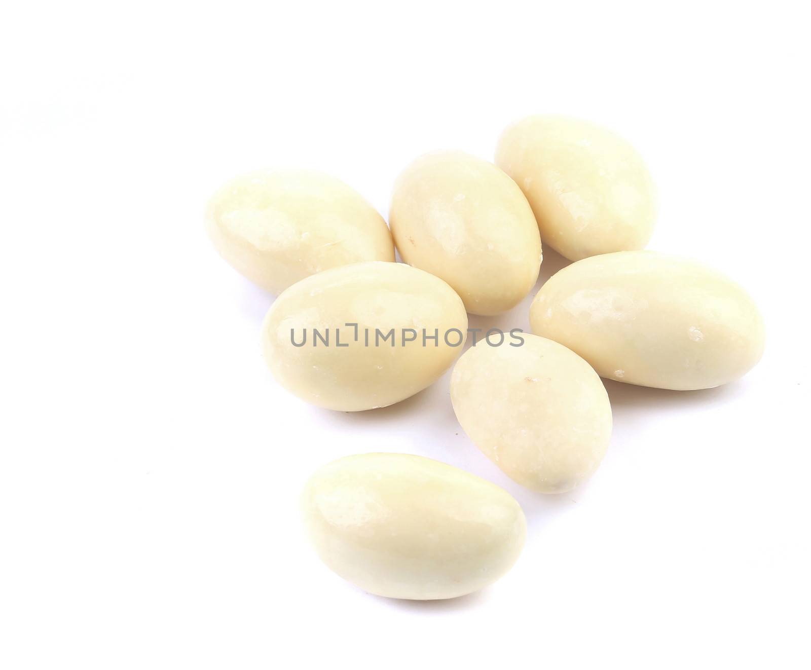 Dragee in white chocolate. Isolated on a white background