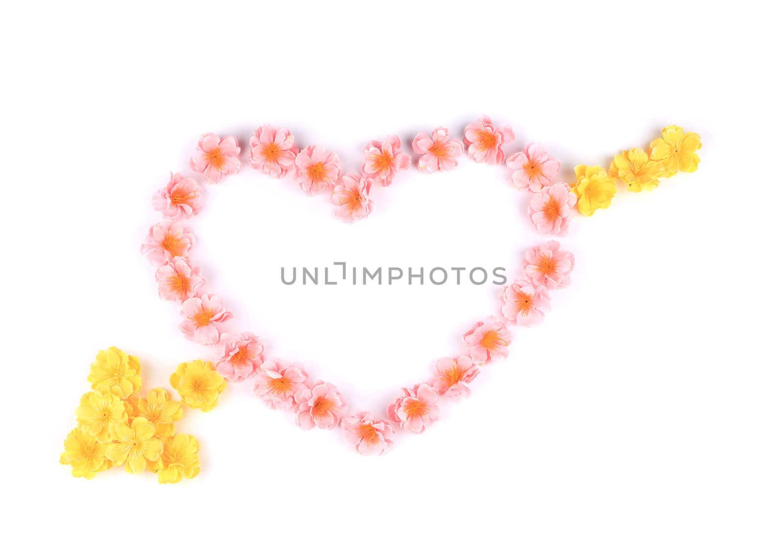 Heart made ??of artificial flowers. On a white background.