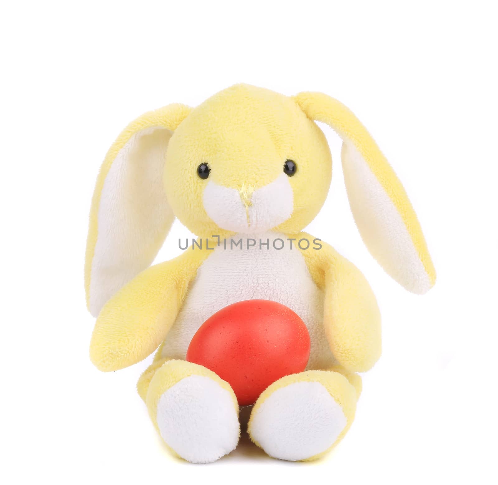 Yellow toy rabbit with easter egg. Isolated on a white background.