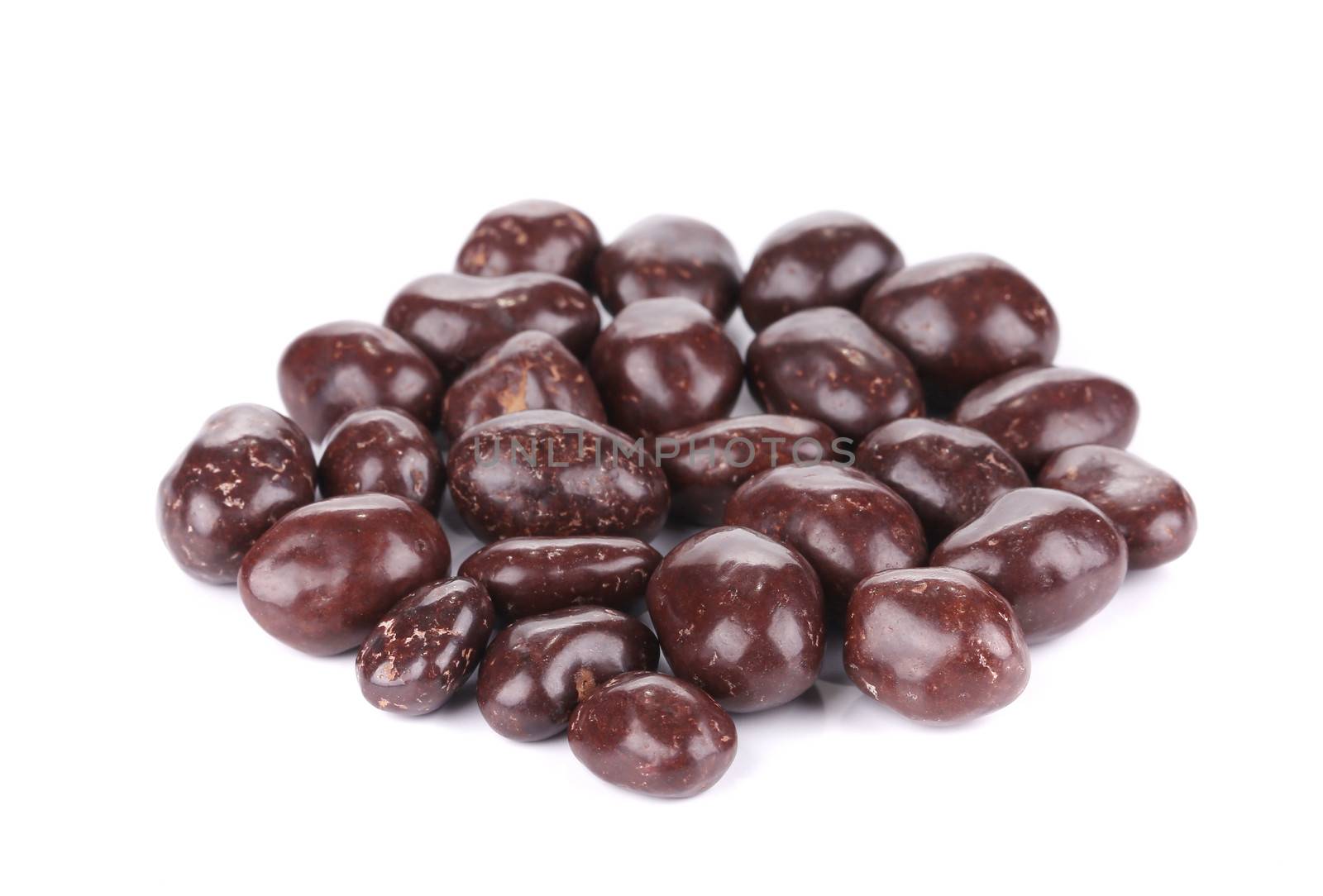 Dark brown dragee in chocolate cover. Isolated on a white background.