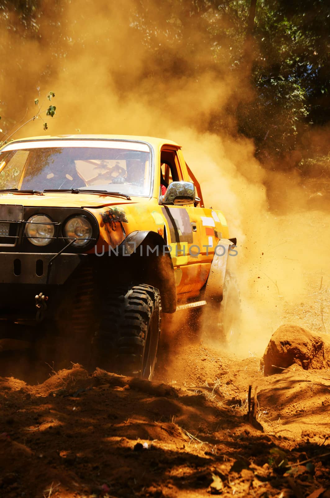 Racer at terrain racing car competition, the car try to cross extreme off road with red earth,  wheel make splash of soil and dusty air, competitor  adventure in championship spirit 