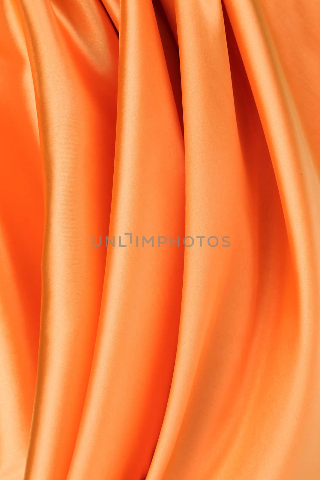 Folded orange silk. To be used as background.