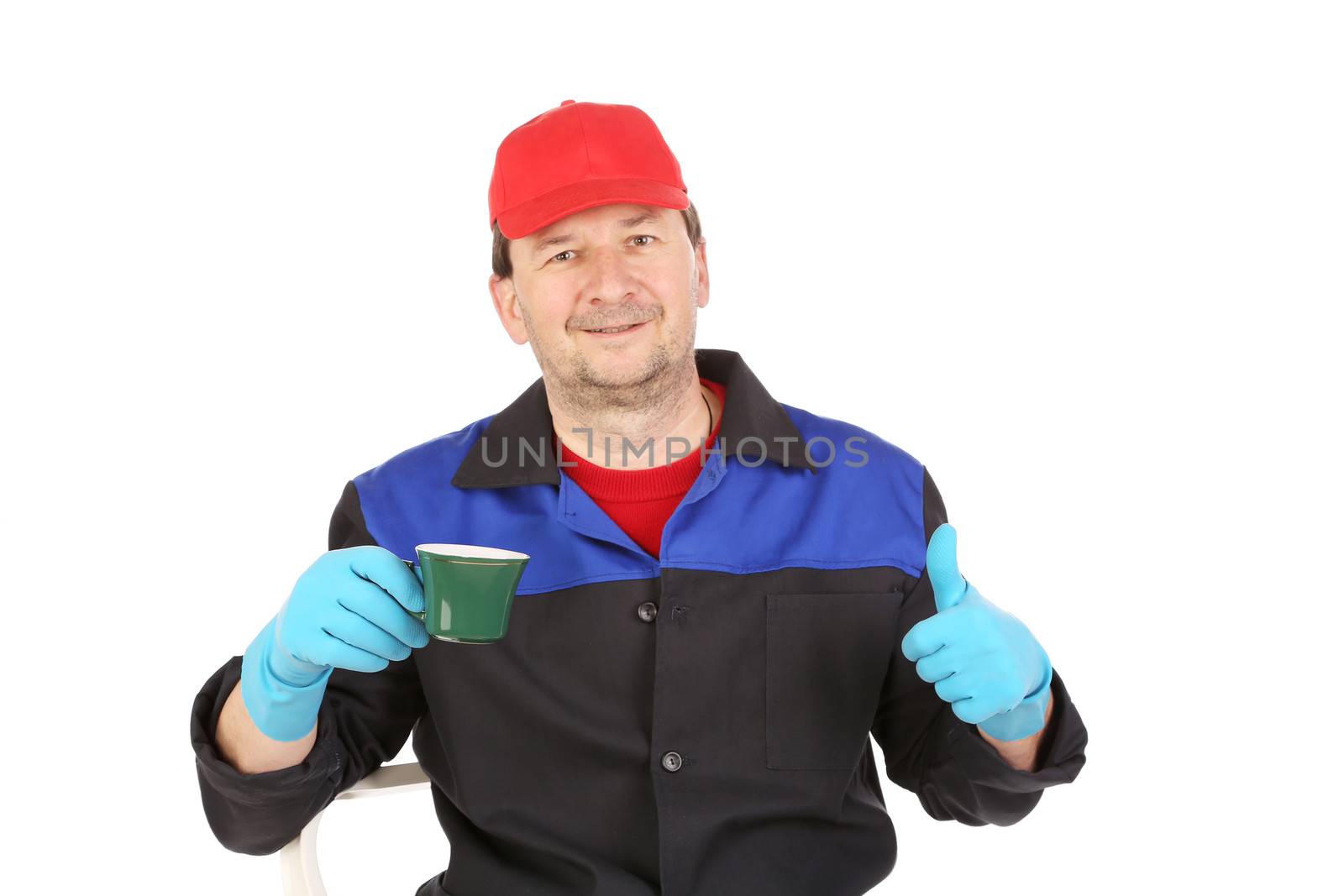 Man in workwear with a cup in hand. Isolated on a white background