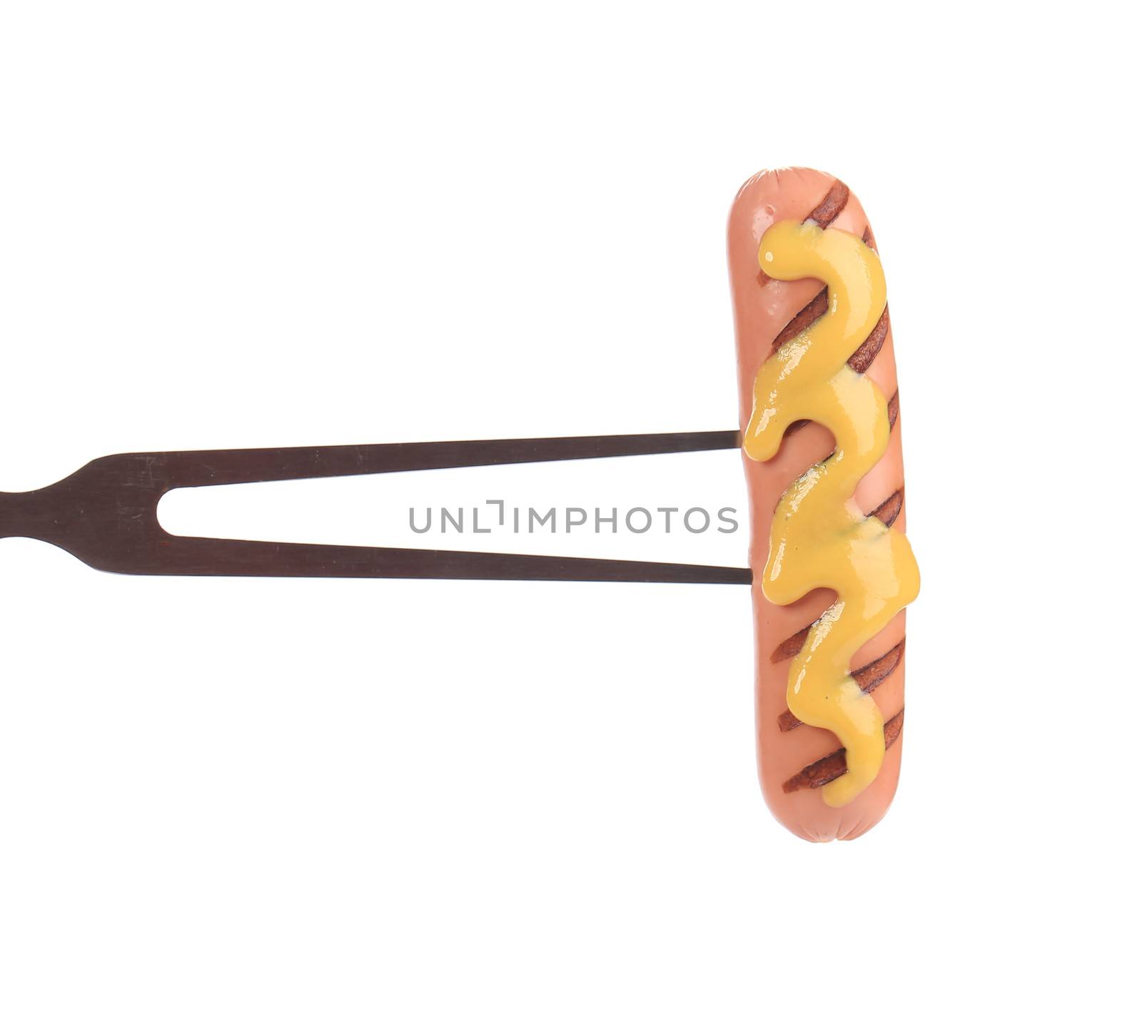 Fried sausage with mustard on a bbq fork