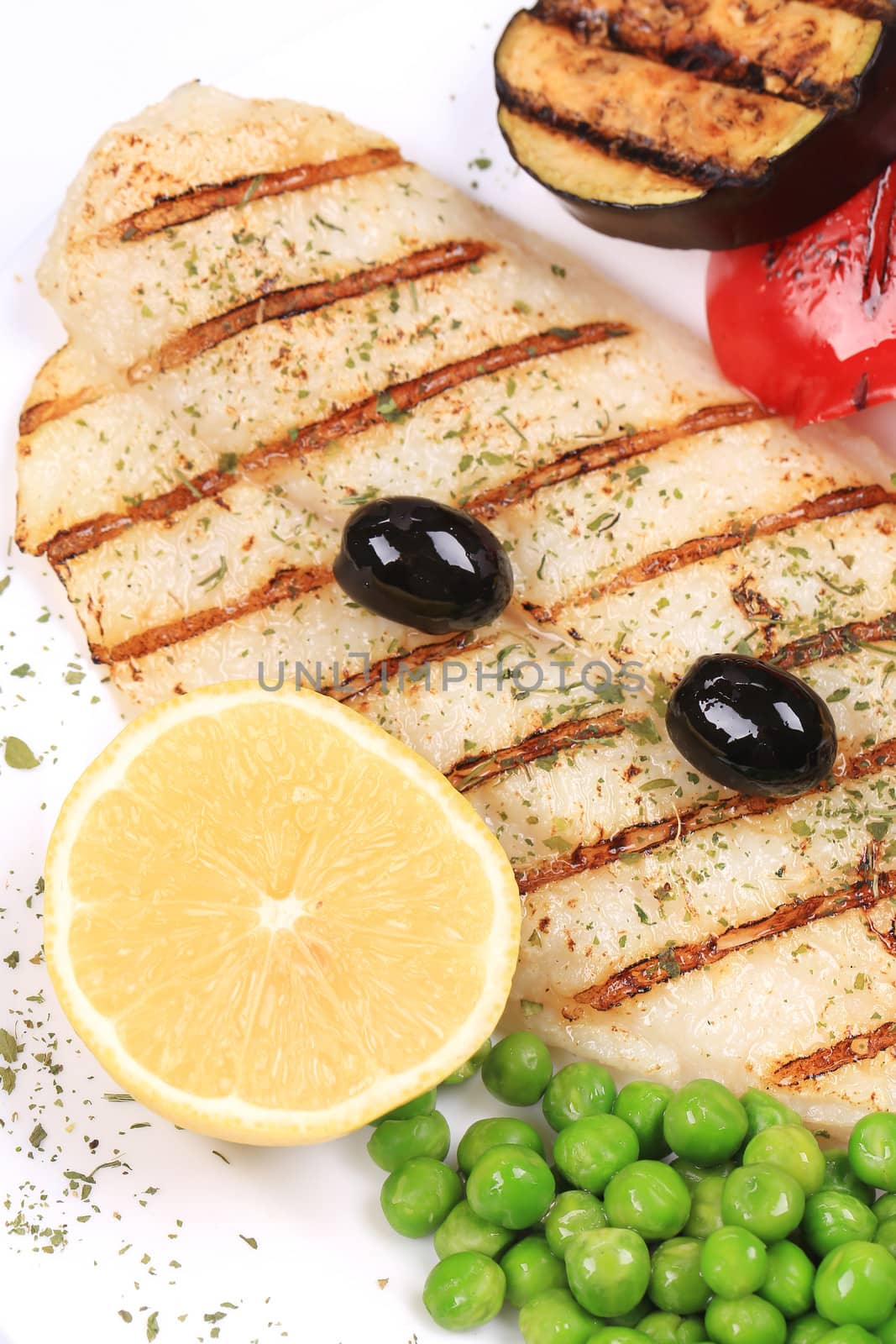 Pangasius fillet grilled with vegetables. Whole background.