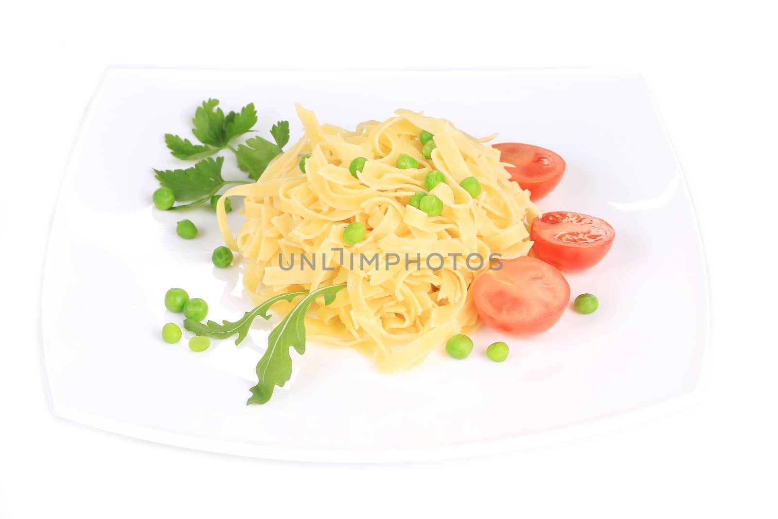 Pasta with green peas on plate close up. Isolated on a white background.
