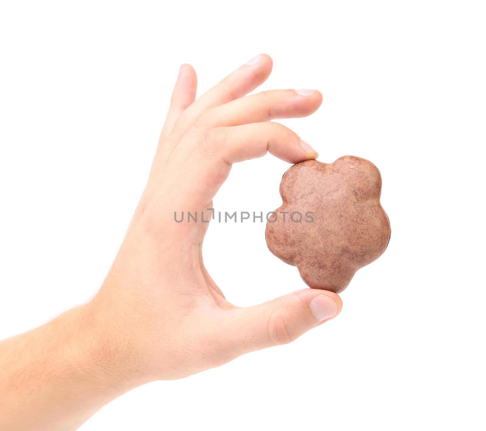 Hand holds chocolate meringues. Isolated on a white background