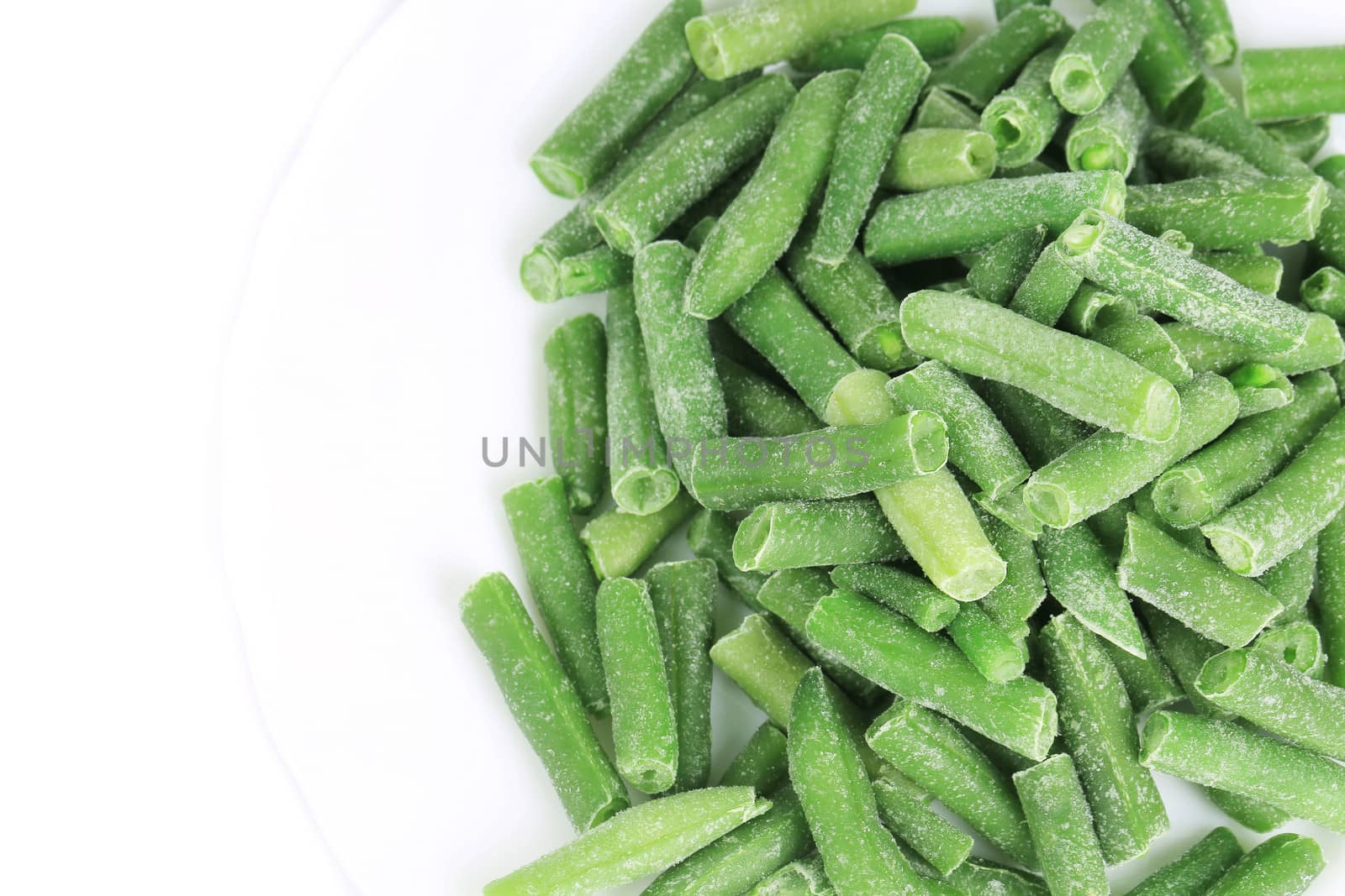 Close up of frozen green beans. Whole background.