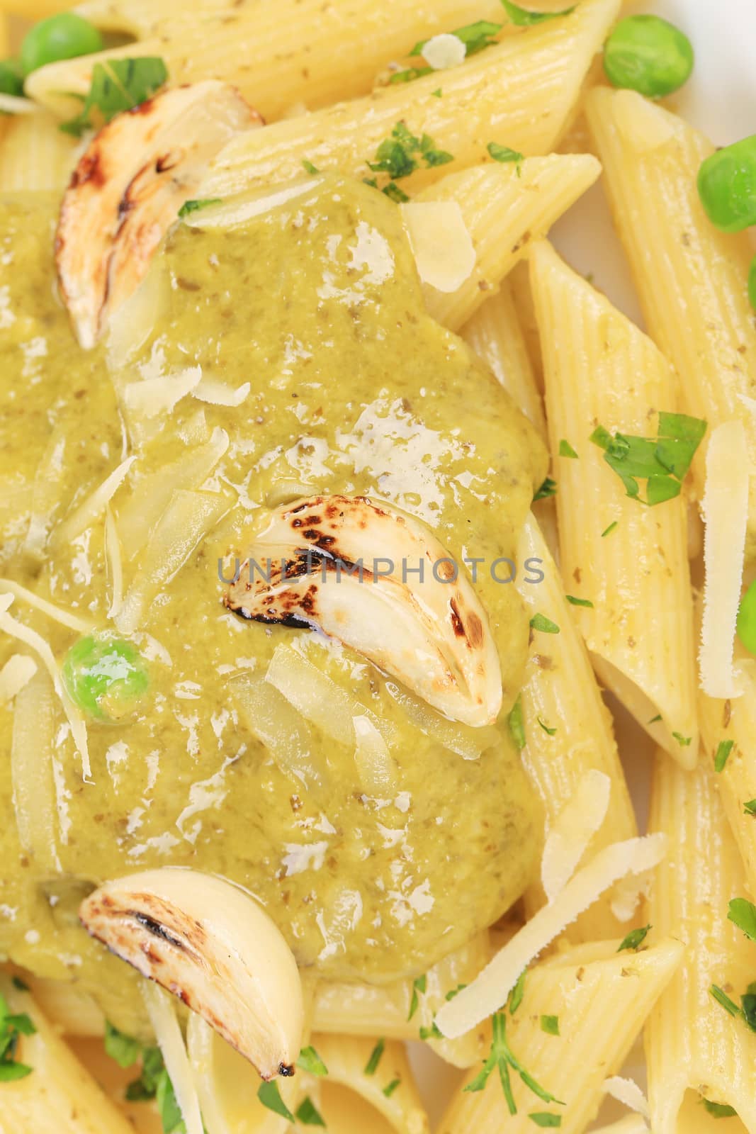 Pasta with pesto sauce. Close up. Whole background.