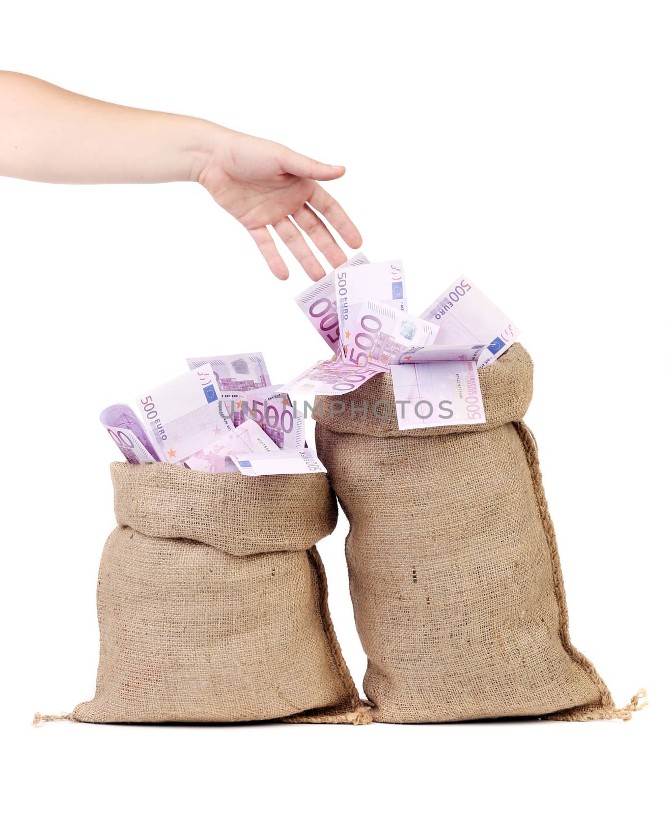 Hand to sacks with euro bills. Isolated on a white background.