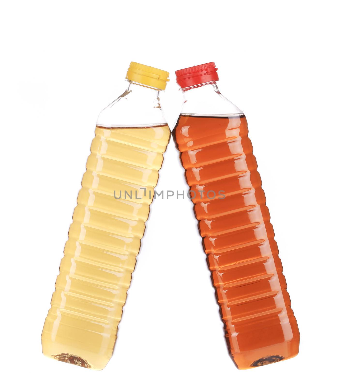close up of bottles with apple and grape vinegar. isolated on a white background