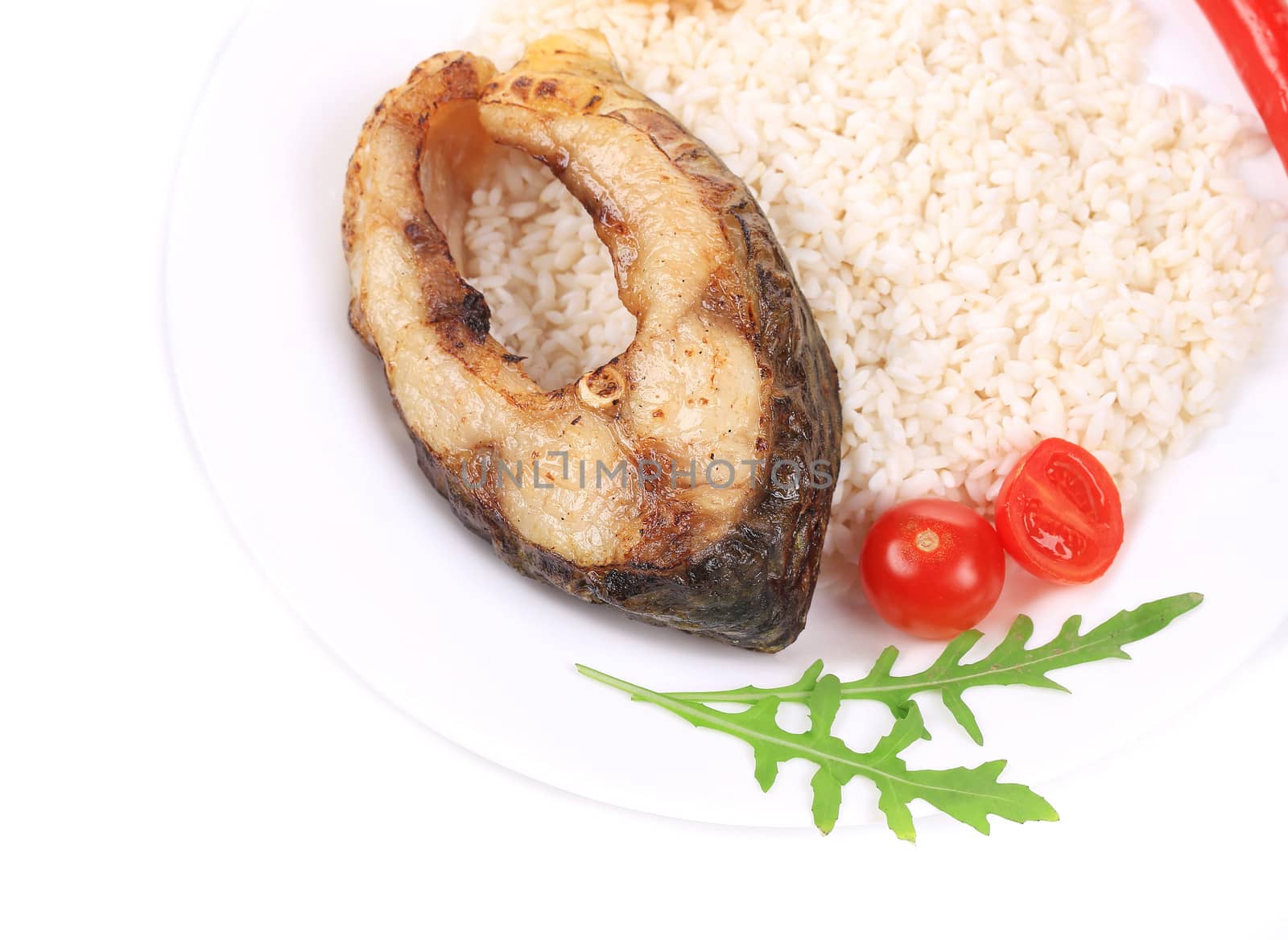 Grilled carp steak with rice. Isolated on a white background.