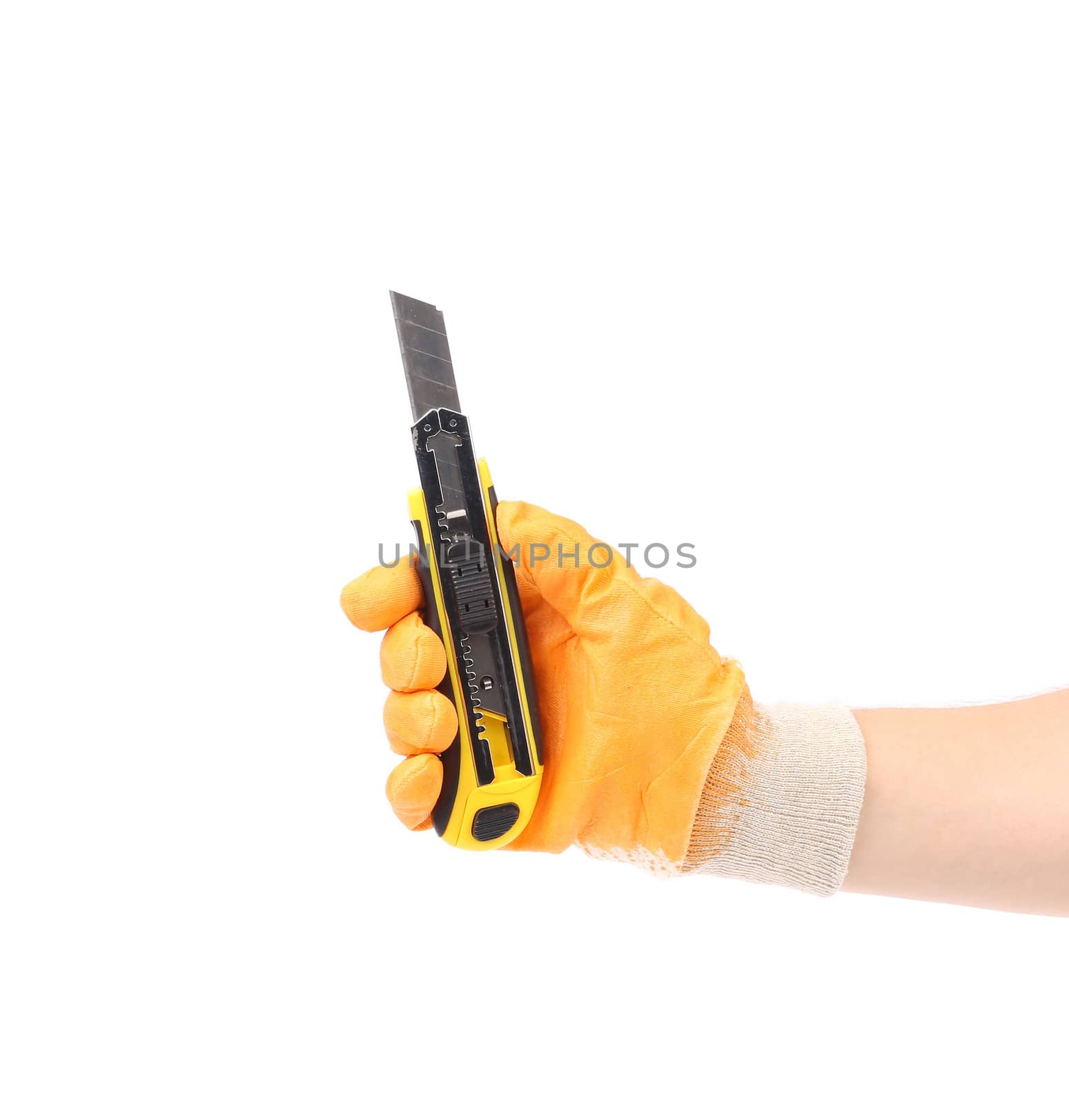 Hand holds yellow stationery knife. Isolated on a white background.
