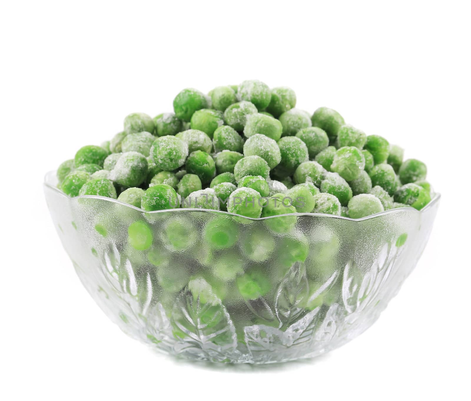 Frozen green peas in glass bowl. Isolated on a white background.