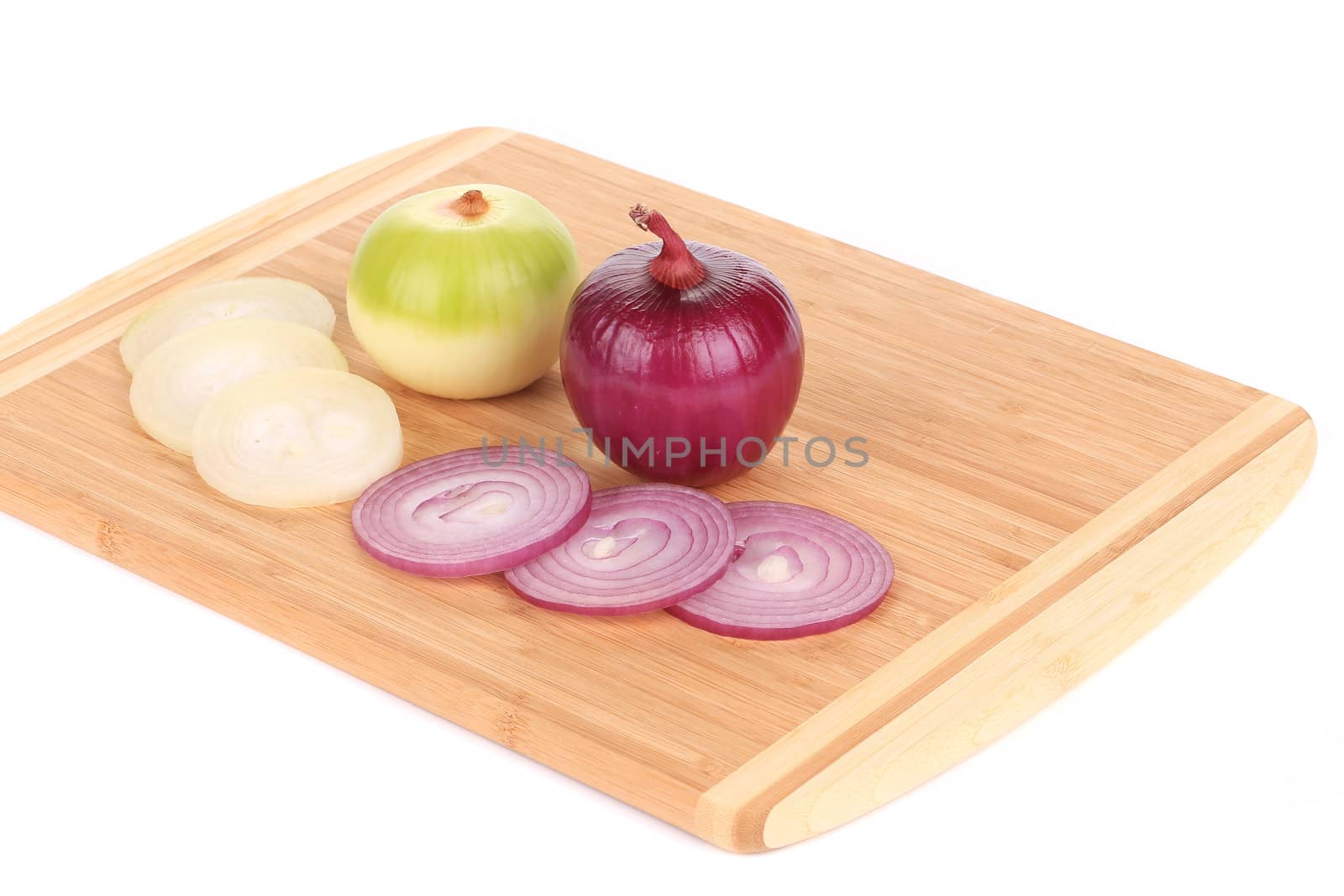 red and white onions on wooden platter. isolated on a white background