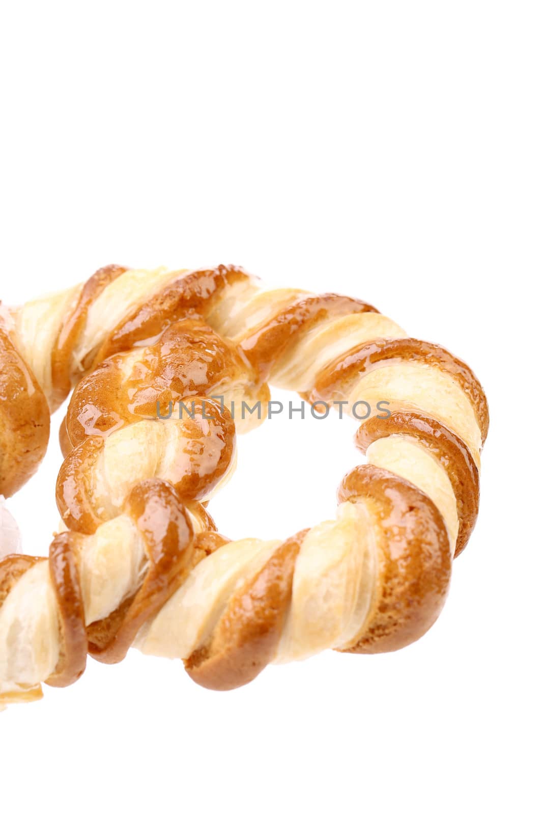Baked bun with honey. Isolated on a white background.