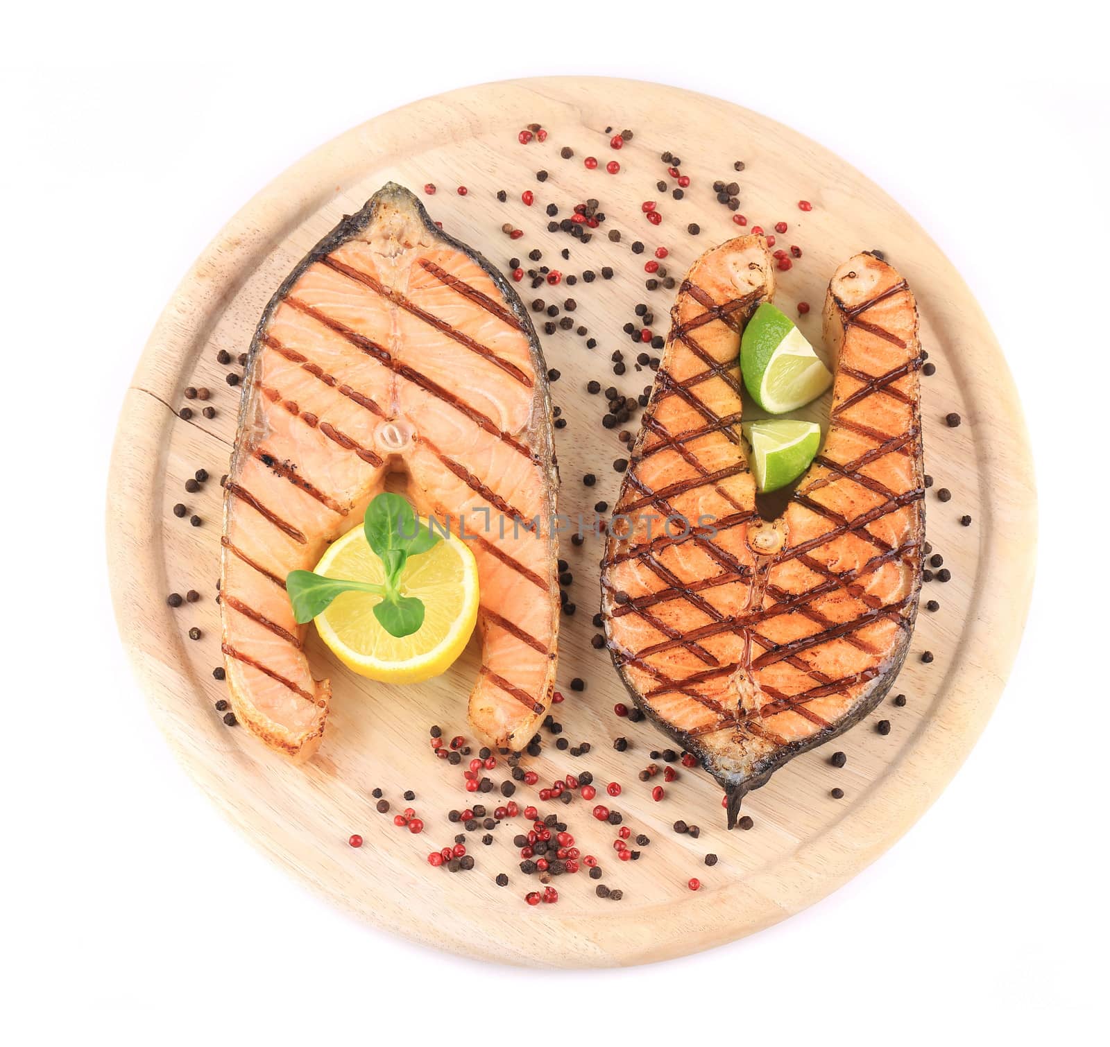 Beautiful salmon steaks on platter. Isolated on a white background.