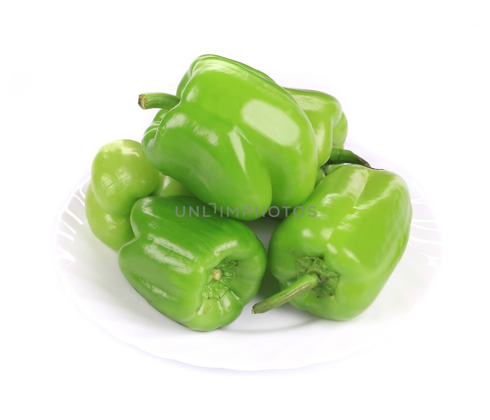 Green peppers in the plate. Isolated on a white background.