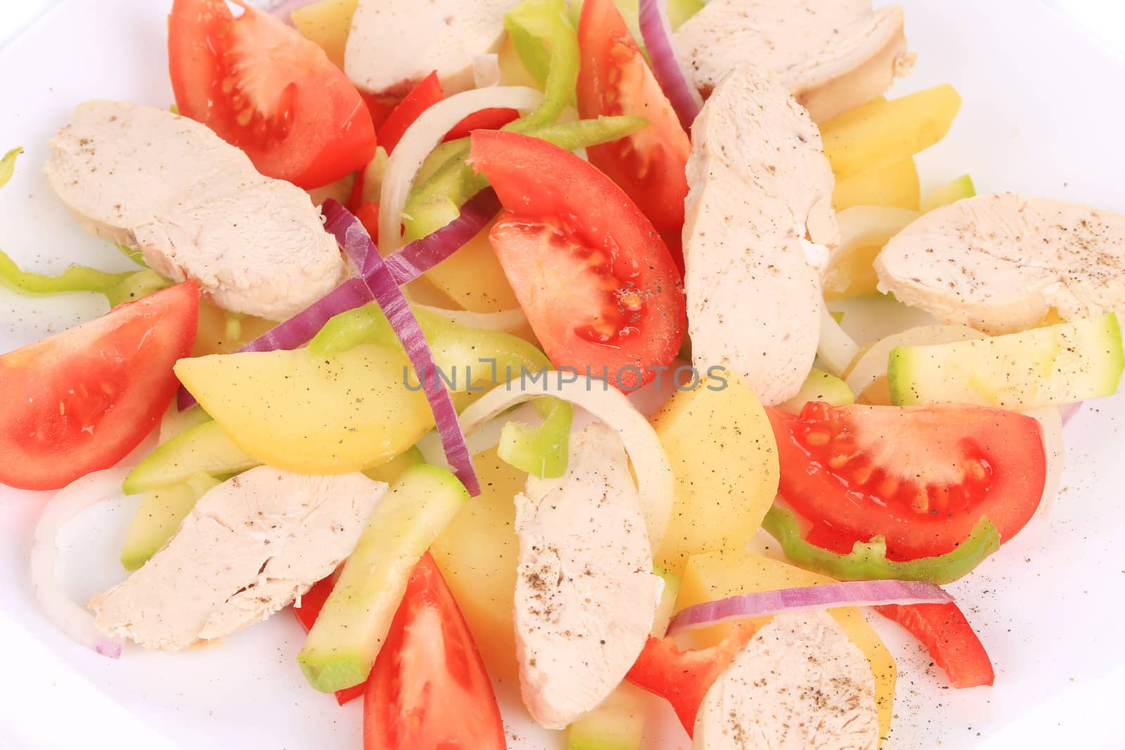 Chicken salad with potatoes. Isolated on a white background.