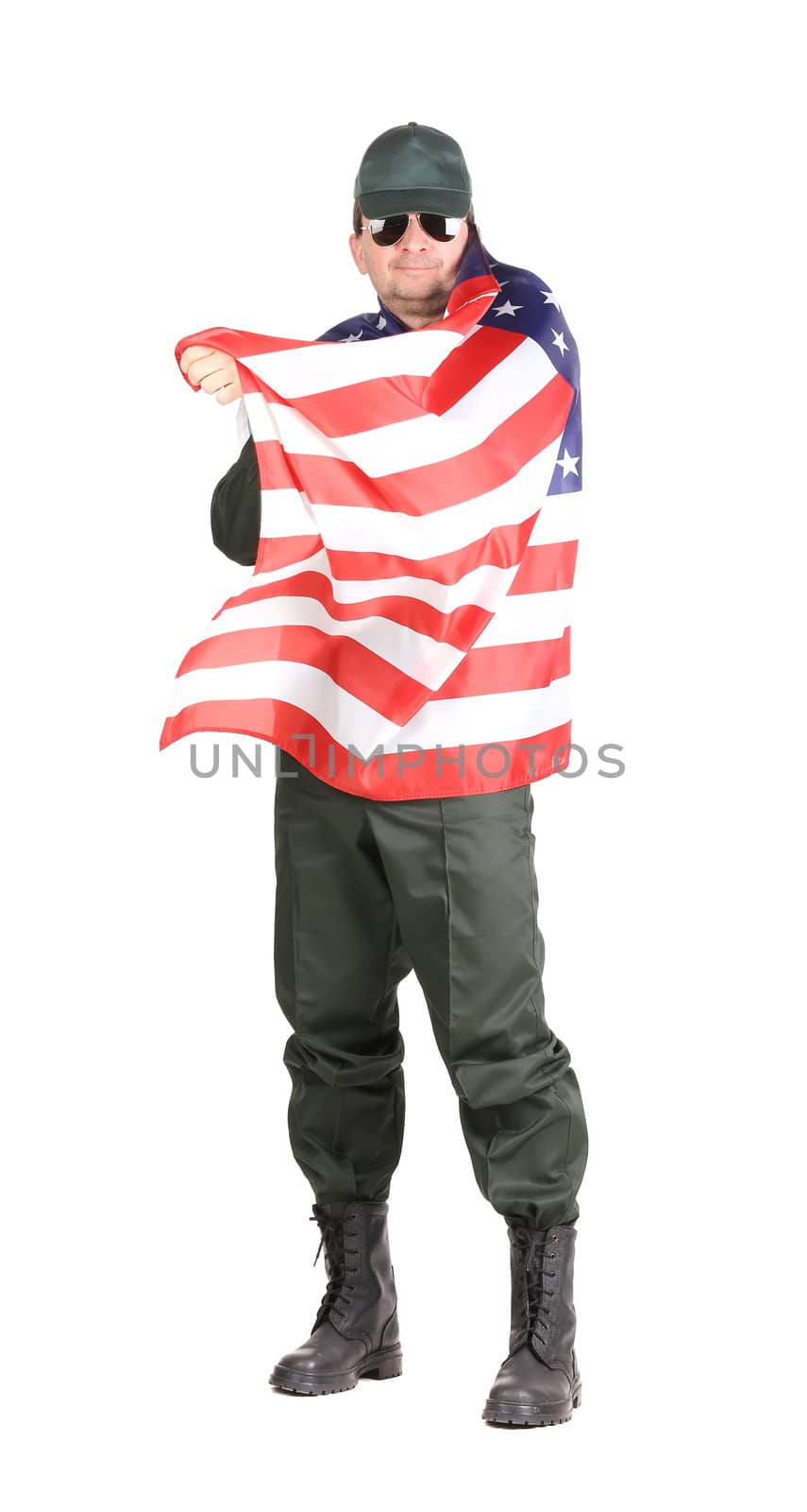 Man in workwear stands with american flag. Isolated on a white background.