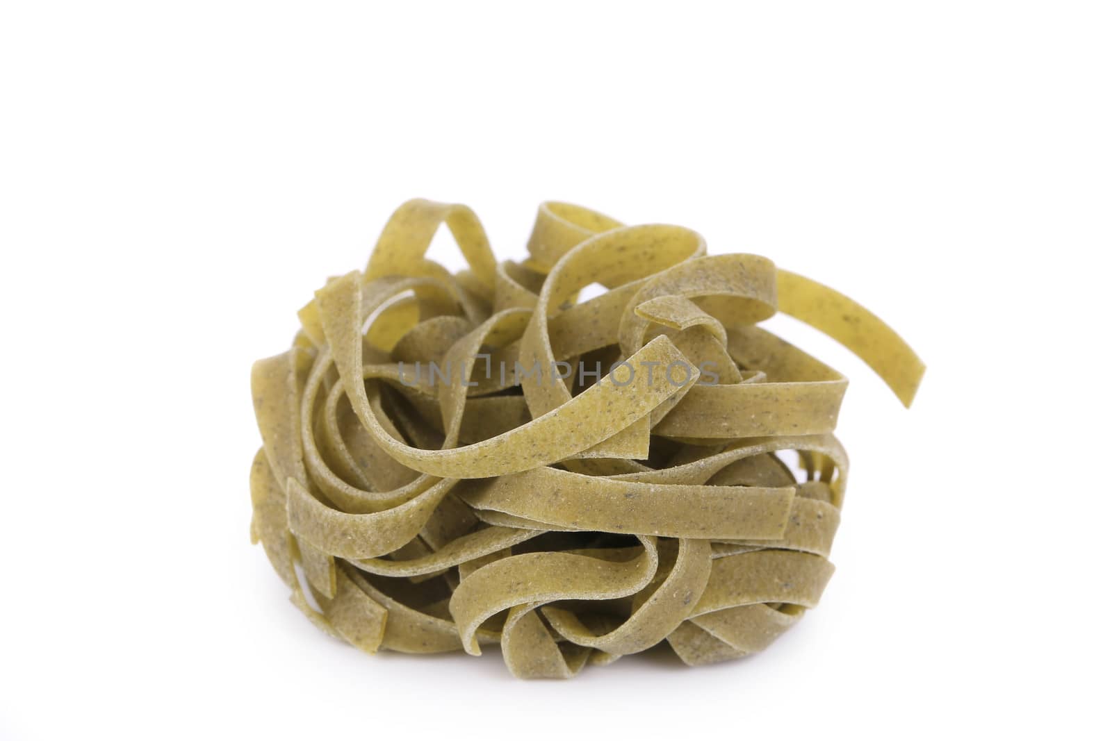A portion of tagliatelle with spinach. Isolated on a white background.