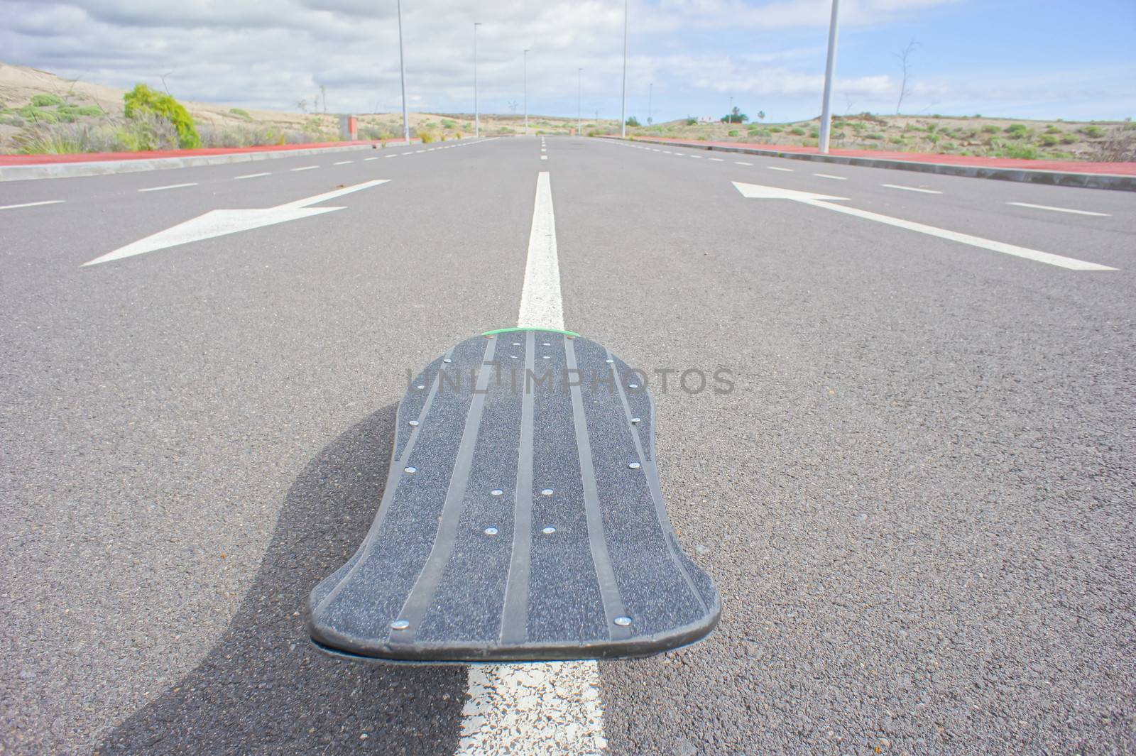 Hdr Picture Vintage Style Longboard Black Skateboard on an Empty Asphalt Desert Road